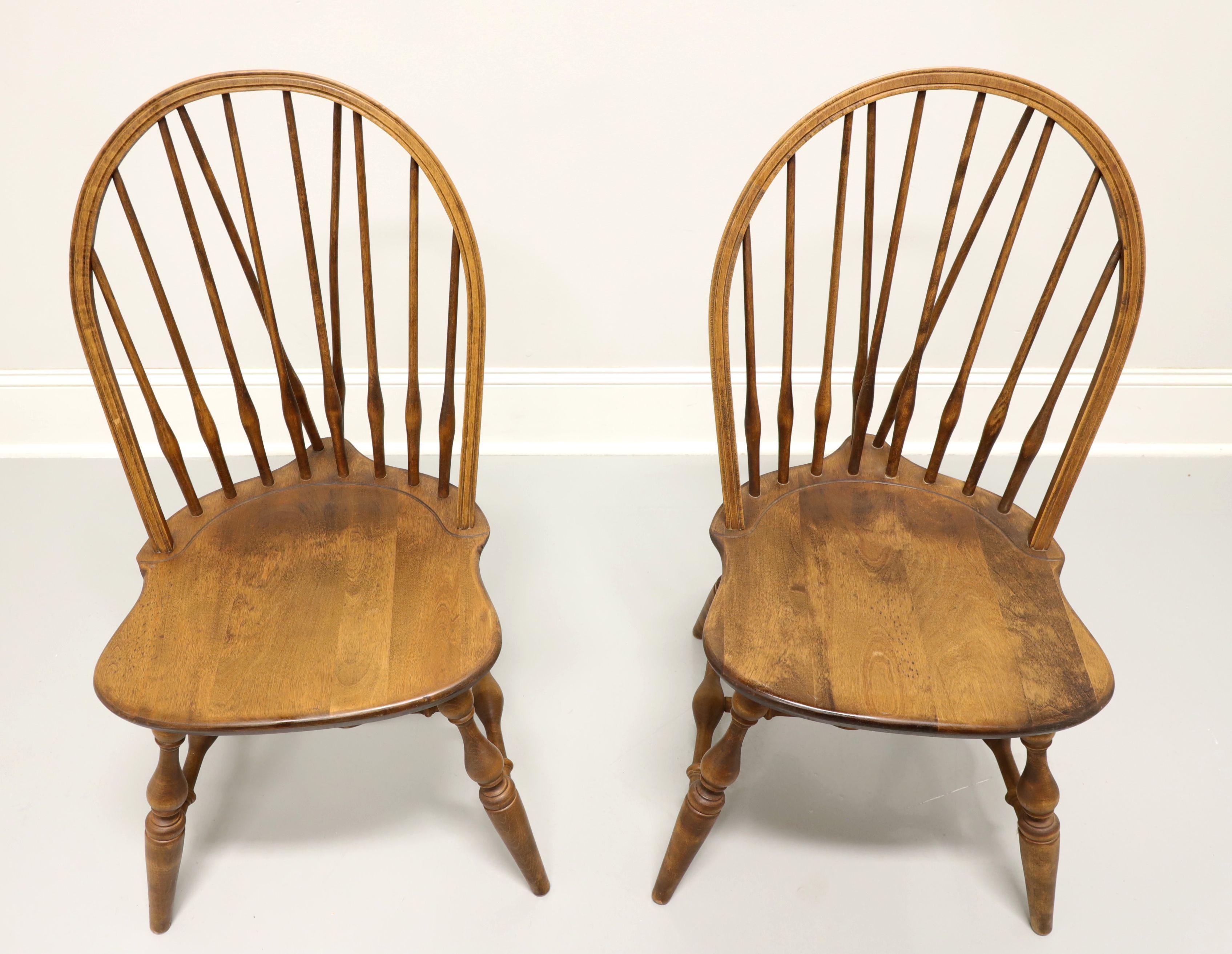 A pair of Windsor style dining side chairs by Habersham Plantation, of Clarksville, Georgia, USA. Solid pine, hoop back with spindles, saddle shape seat, tail-supports with spindles, turned legs and stretchers. Made in the late 20th