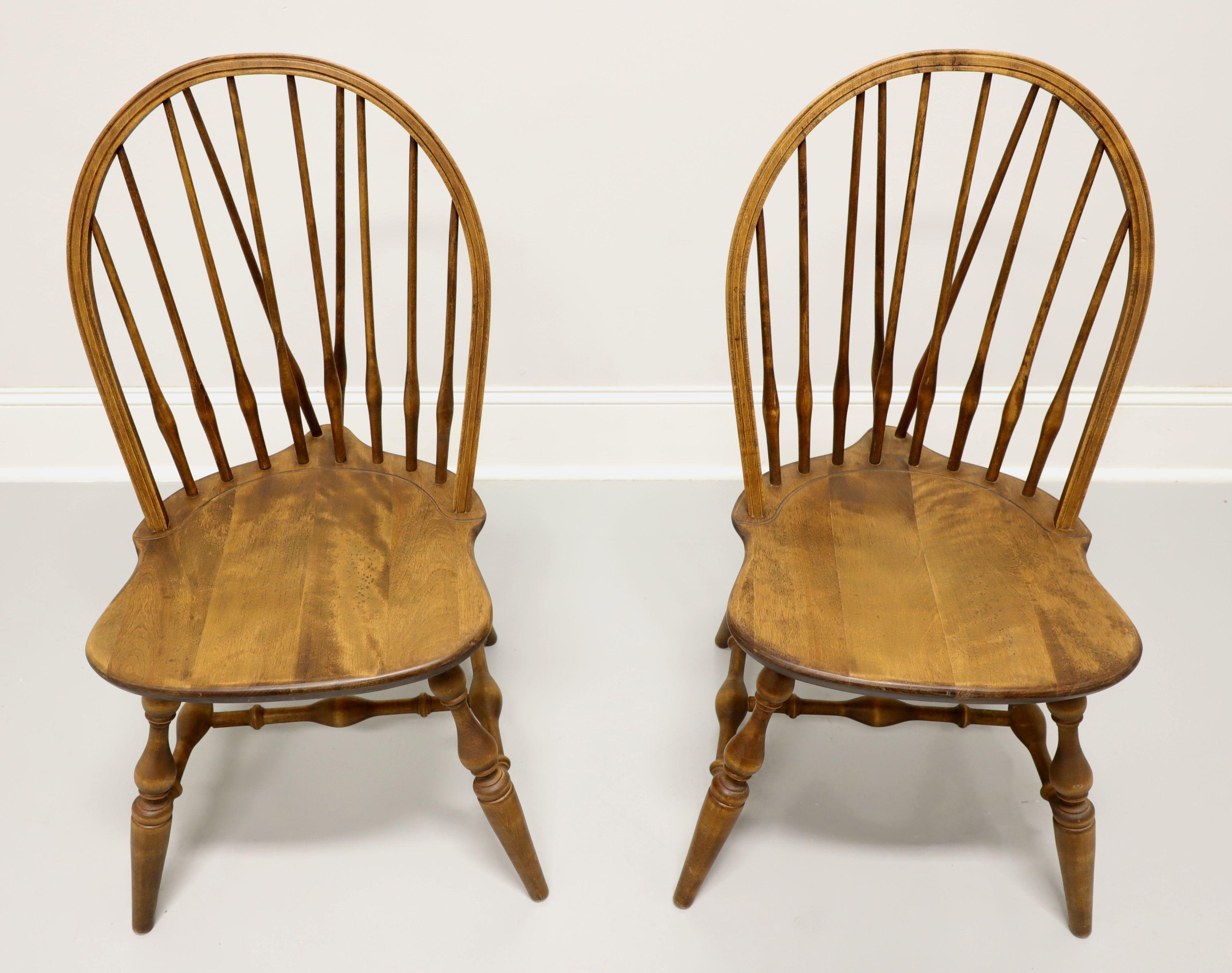 A pair of Windsor style dining side chairs by Habersham Plantation, of Clarksville, Georgia, USA. Solid pine, hoop back with spindles, saddle shape seat, tail-supports with spindles, turned legs and stretchers. Made in the late 20th