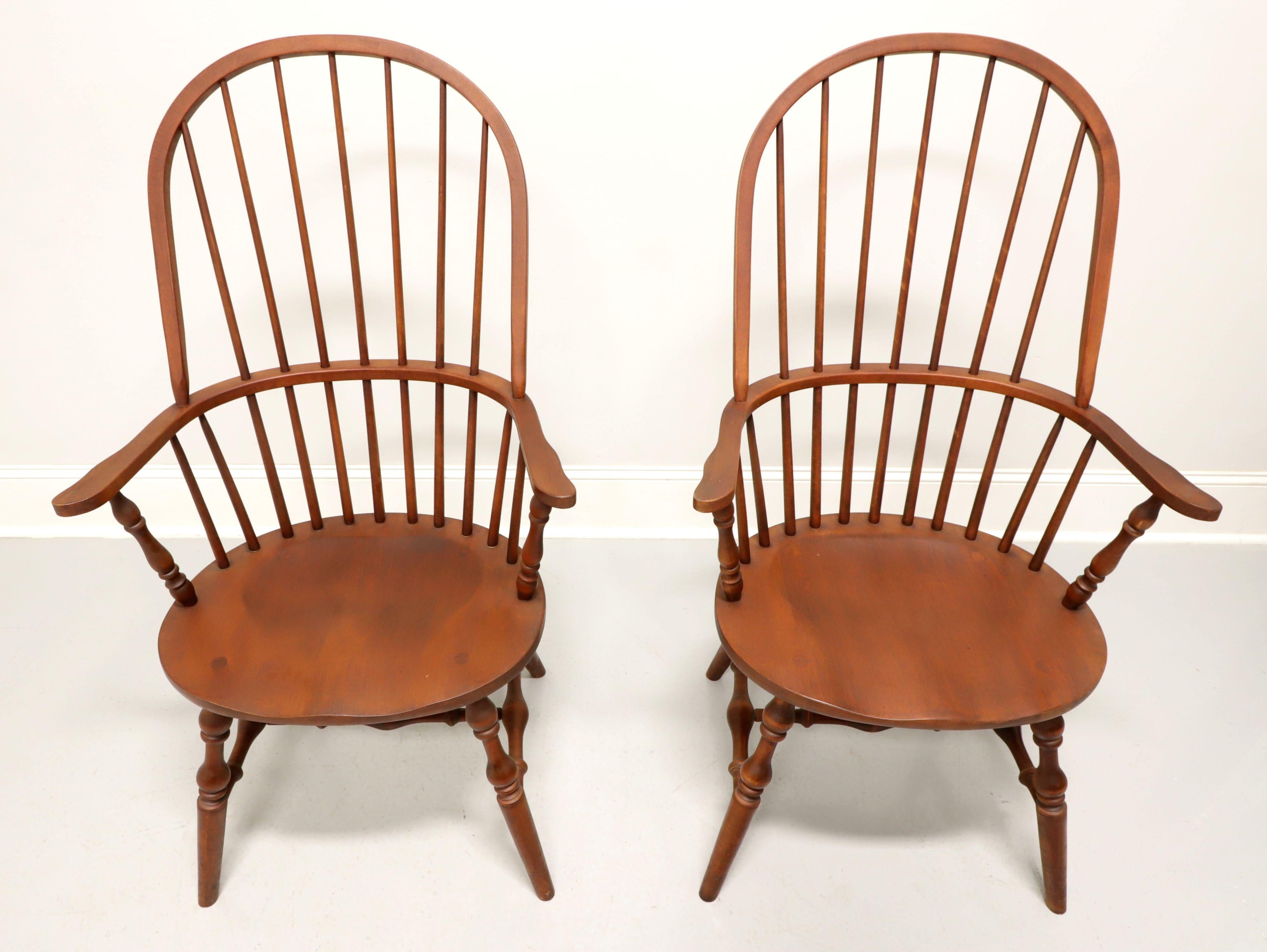 A pair of Windsor style dining armchairs by Habersham Plantation, of Toccoa, Georgia, USA. Solid maple, hoop back with spindles, curved arms with turned post supports, saddle shape seat, turned legs and stretchers. Made in the late 20th