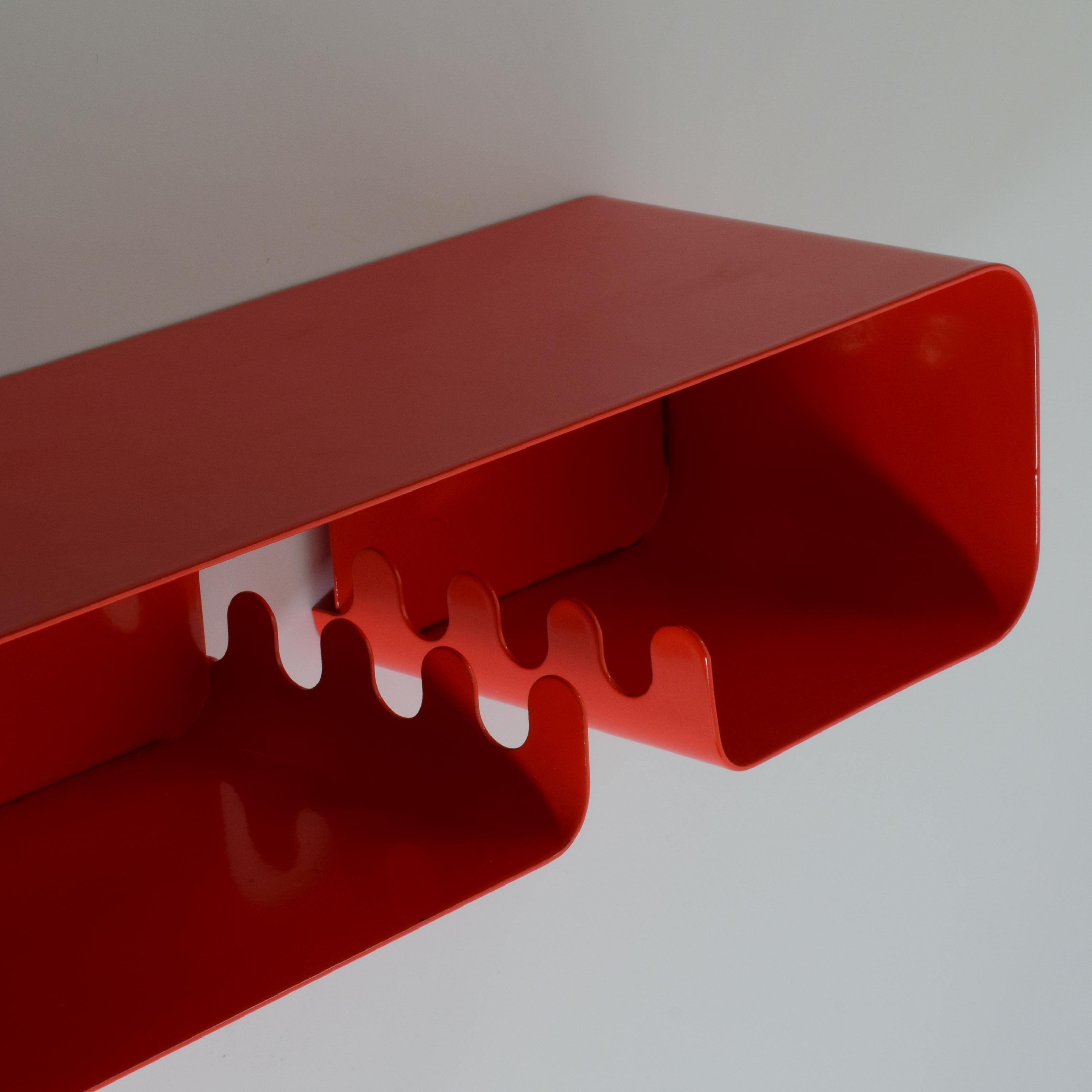 Habitat 'Pop' shelf unit, c. 1980s.
Red lacquered metal with integrated finger-like towel or coat hooks.
Super little wall-mounted shelf units, ideal for entrance areas, kitchens, bathrooms and cloakrooms. 

These units are individually