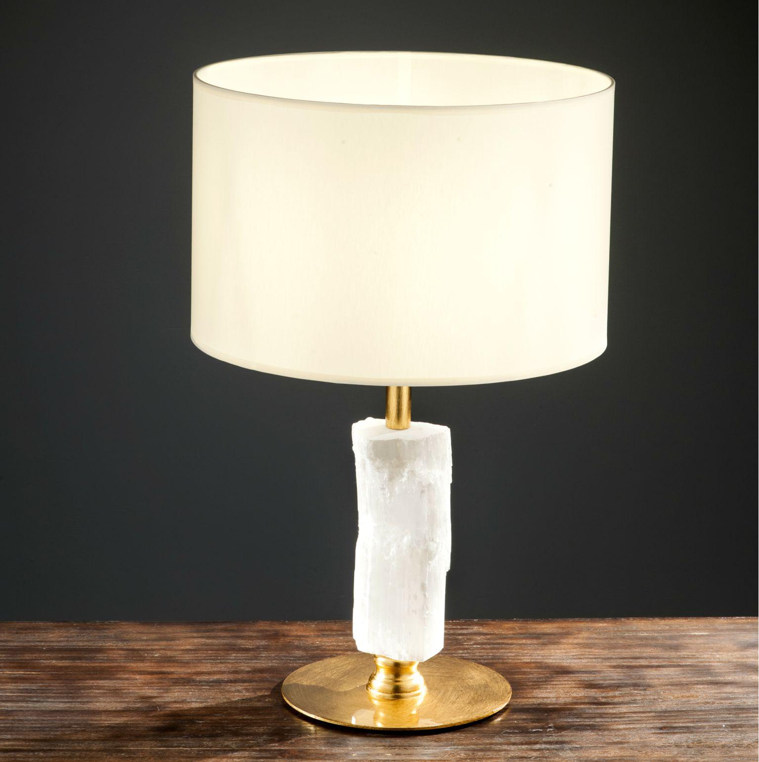 Hadley selenite table lamp
Dimensions: Diameter 40 x height 64 cm 
Materials: Aluminum, plated with gold leaf. Natural selenite or moroccan rock.
Lighting: 01 x E27
Finish: Silver veneer, aged silver veneer, gold veneer, aged gold veneer, copper