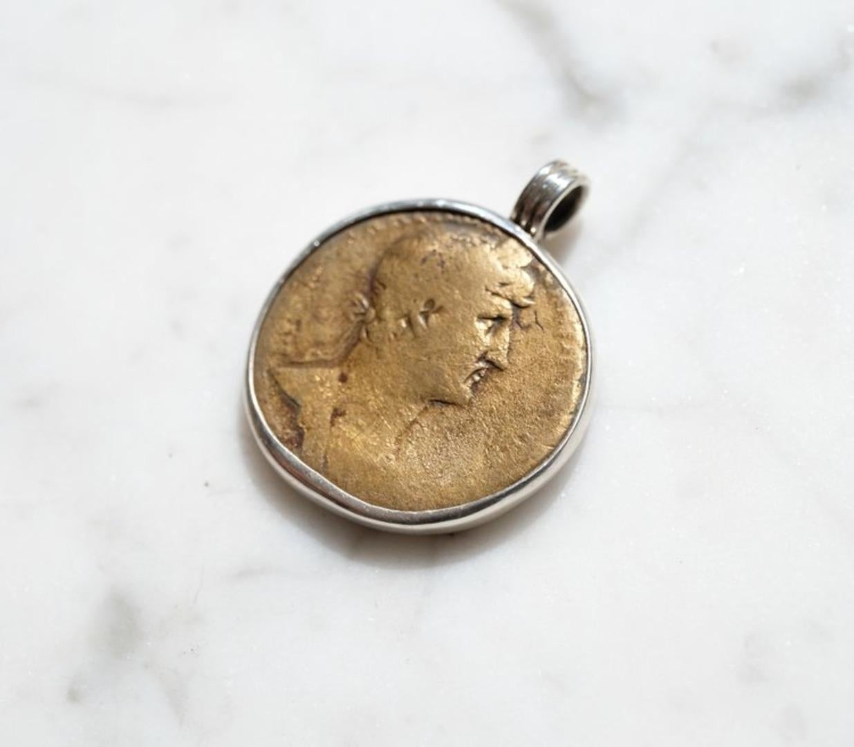 Beautifully colored Roman sestertius showing Hadrian and Spes (Goddess of Hope). I purchased this coin from a European coin dealer.

To appreciate the pendant's size, the relief of the coin and the shape of the bail, see the picture showing the coin