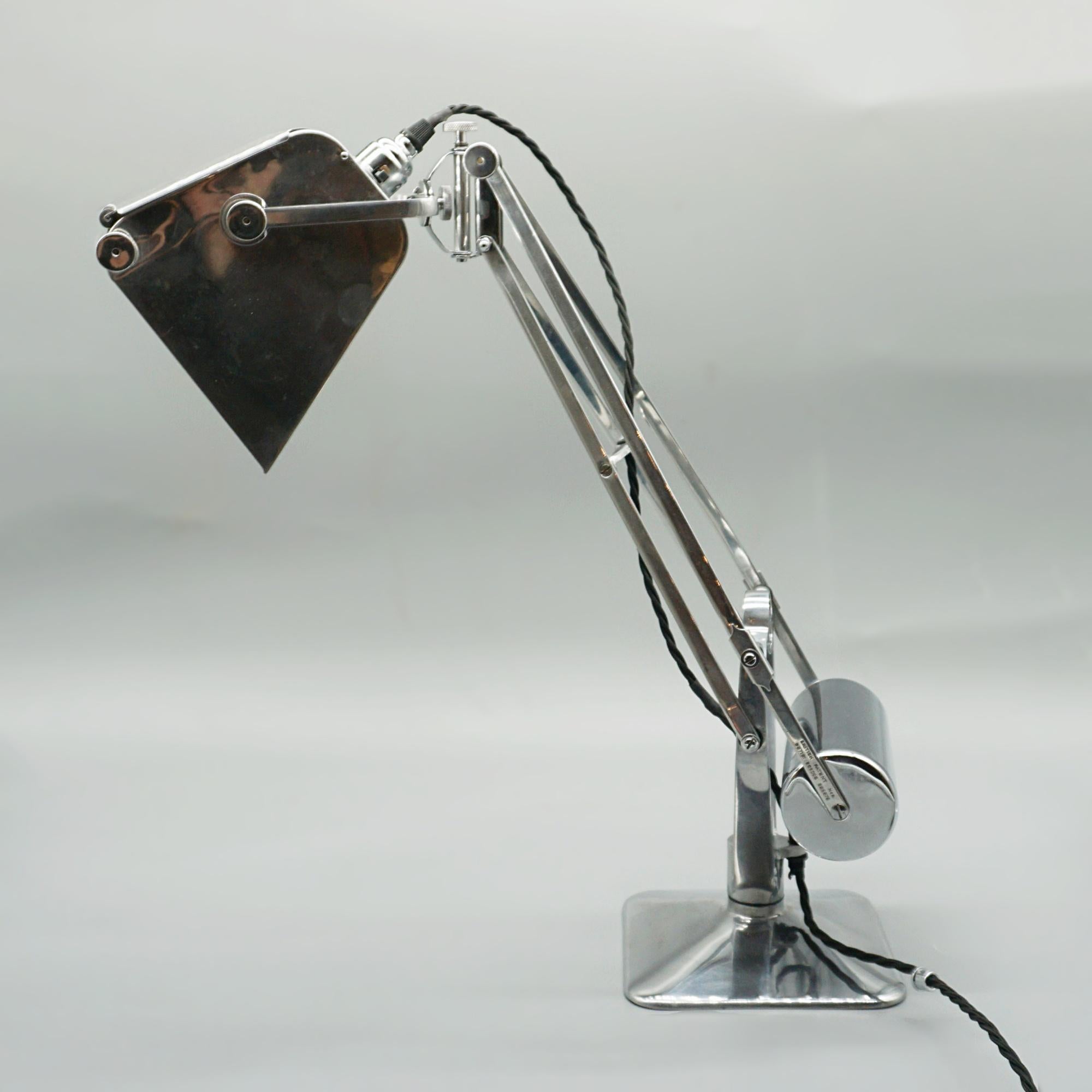 A pluslite table lamp with magnifying glass by Hadrill & Horstmann. Originally designed and used for map reading. 

Dimensions: H 47cm W 20cm D 20cm

Origin: English

Date: Circa 1940

Item Number: J360

All of our lighting is fully refurbished,