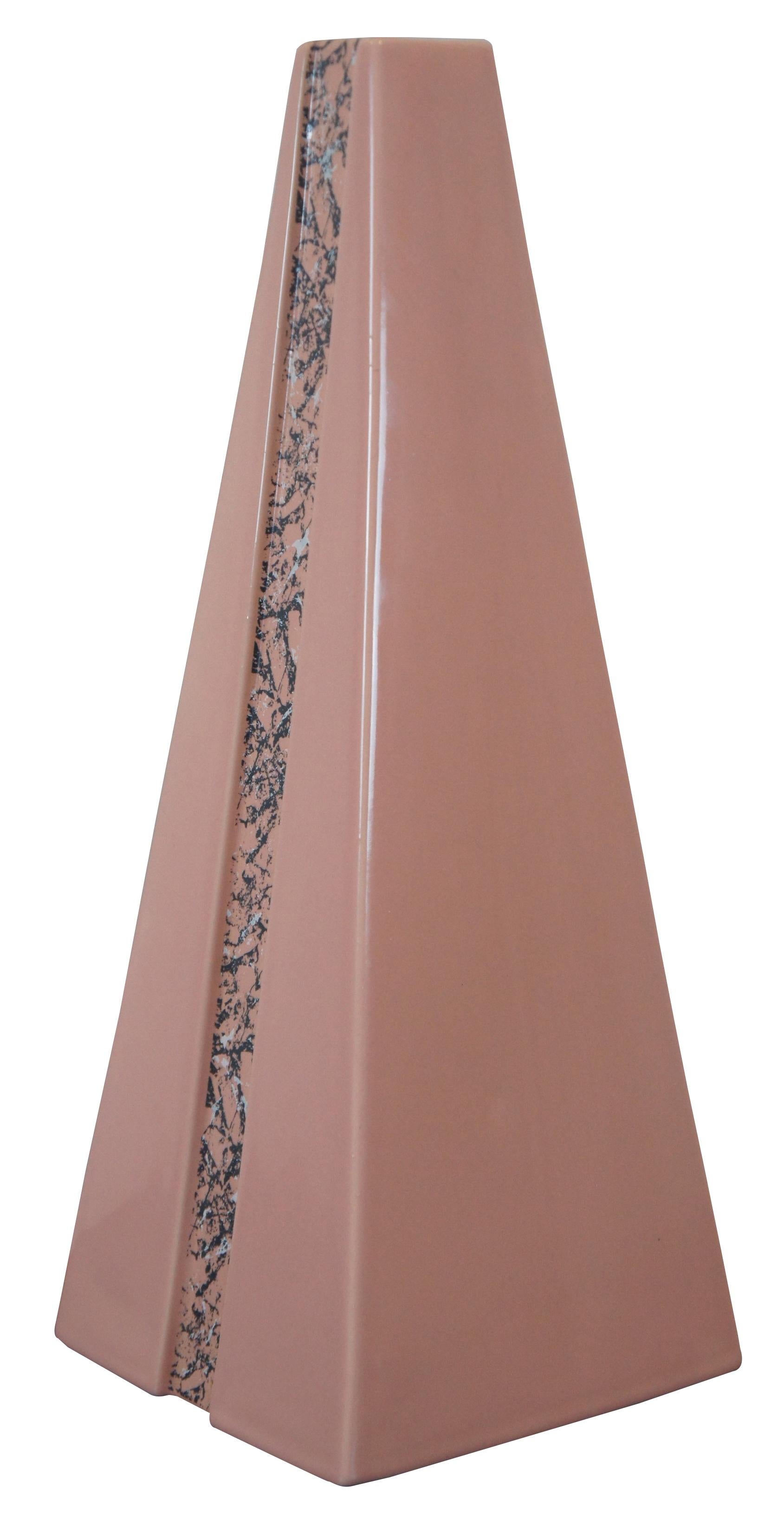 Vintage Art Deco style Haegar vase shaped like a tall pink pyramid with inset marble patterned stripes along the length. Measures: 18”.
  