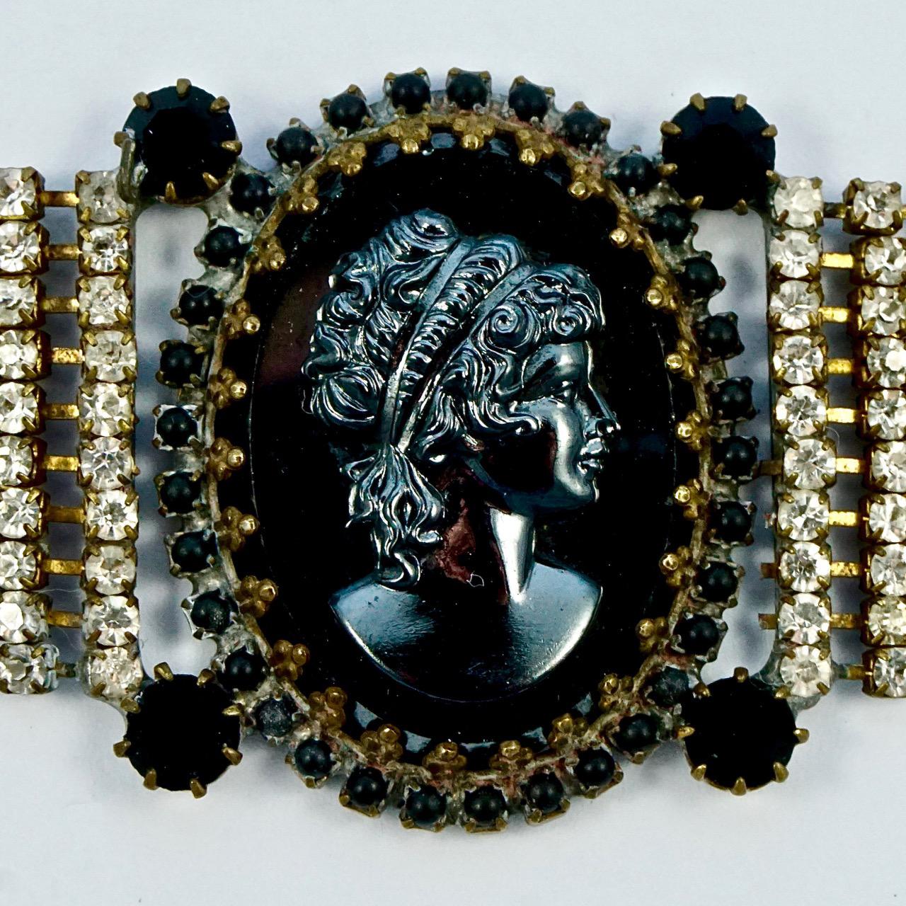 Lovely clear rhinestone bracelet featuring a shiny haematite cameo with matt black glass edging and four black rhinestones. The bracelet is most likely Czech. Measuring length 17.5cm / 6.9 inches, and the band is width is 2.4cm / .94 inch. Part of