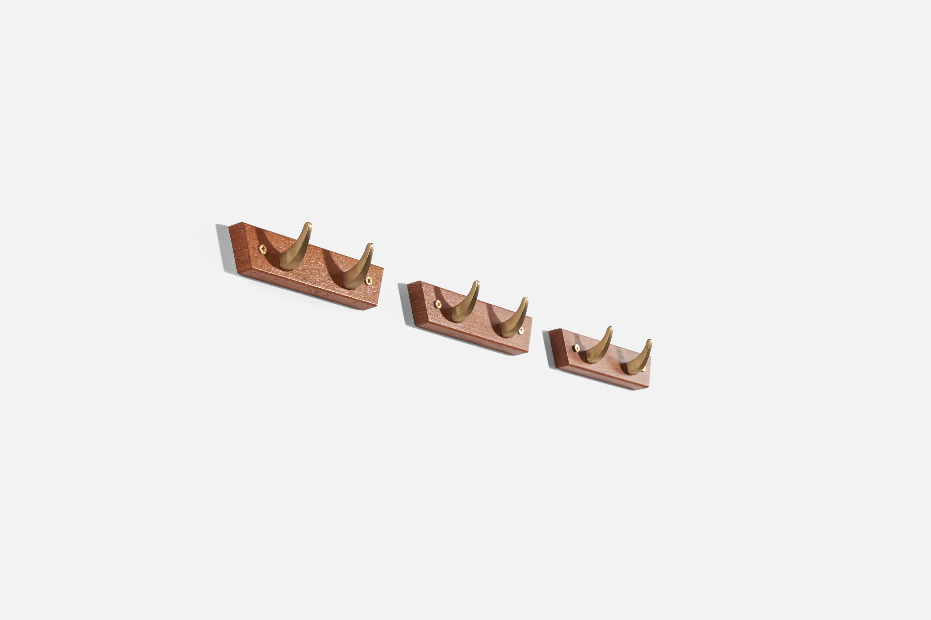A set of three brass and teak coat hangers produced by Hafa, Sweden, 1960s.