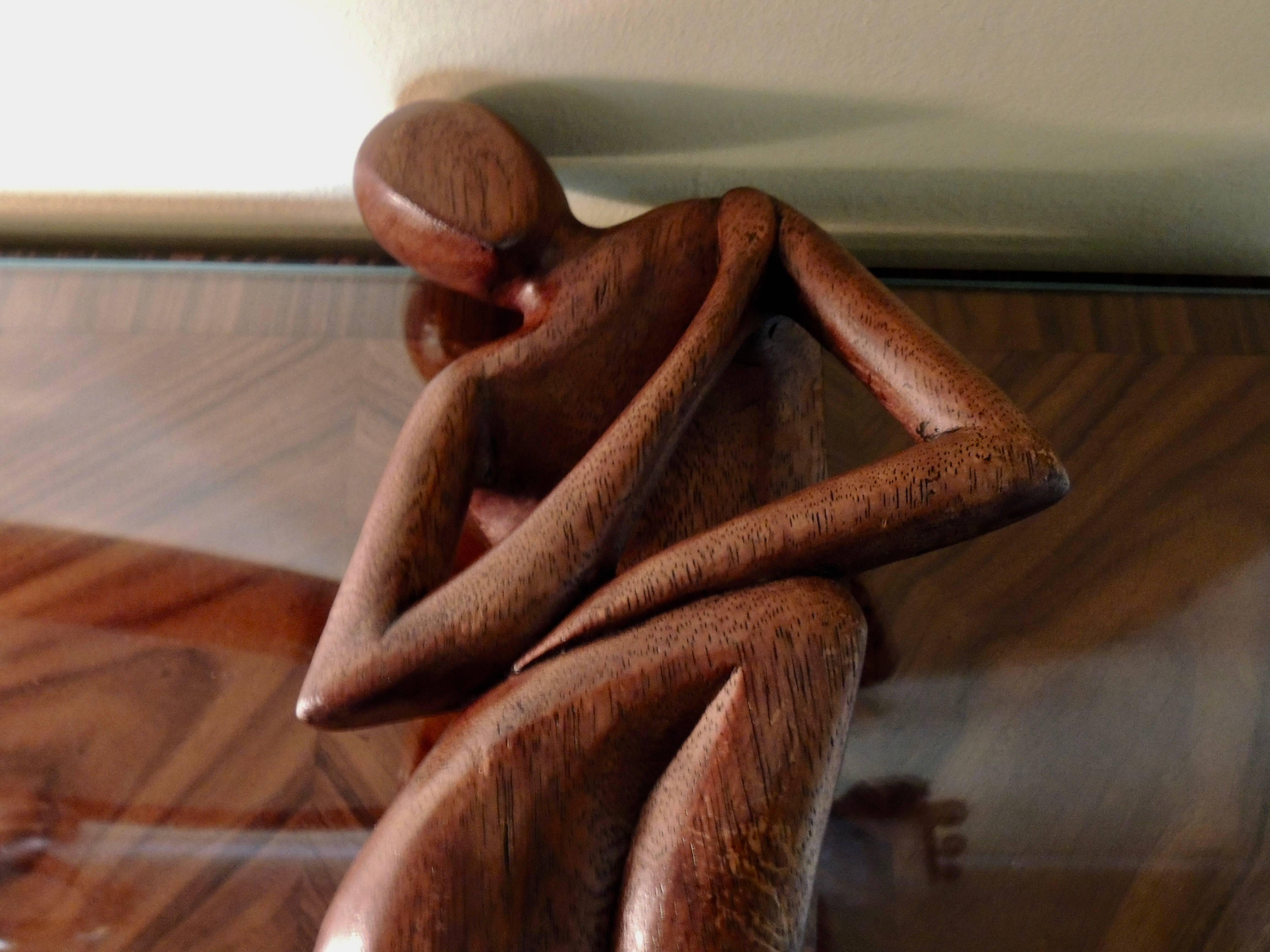 This Art Deco seated figure by Franz Hagenauer is one of the most graceful designs to have come from the “Werkstatte Hagenauer of Wien”. Carved of oak, stained a rich reddish brown tone and mounted on a chrome base this piece is more elegant than