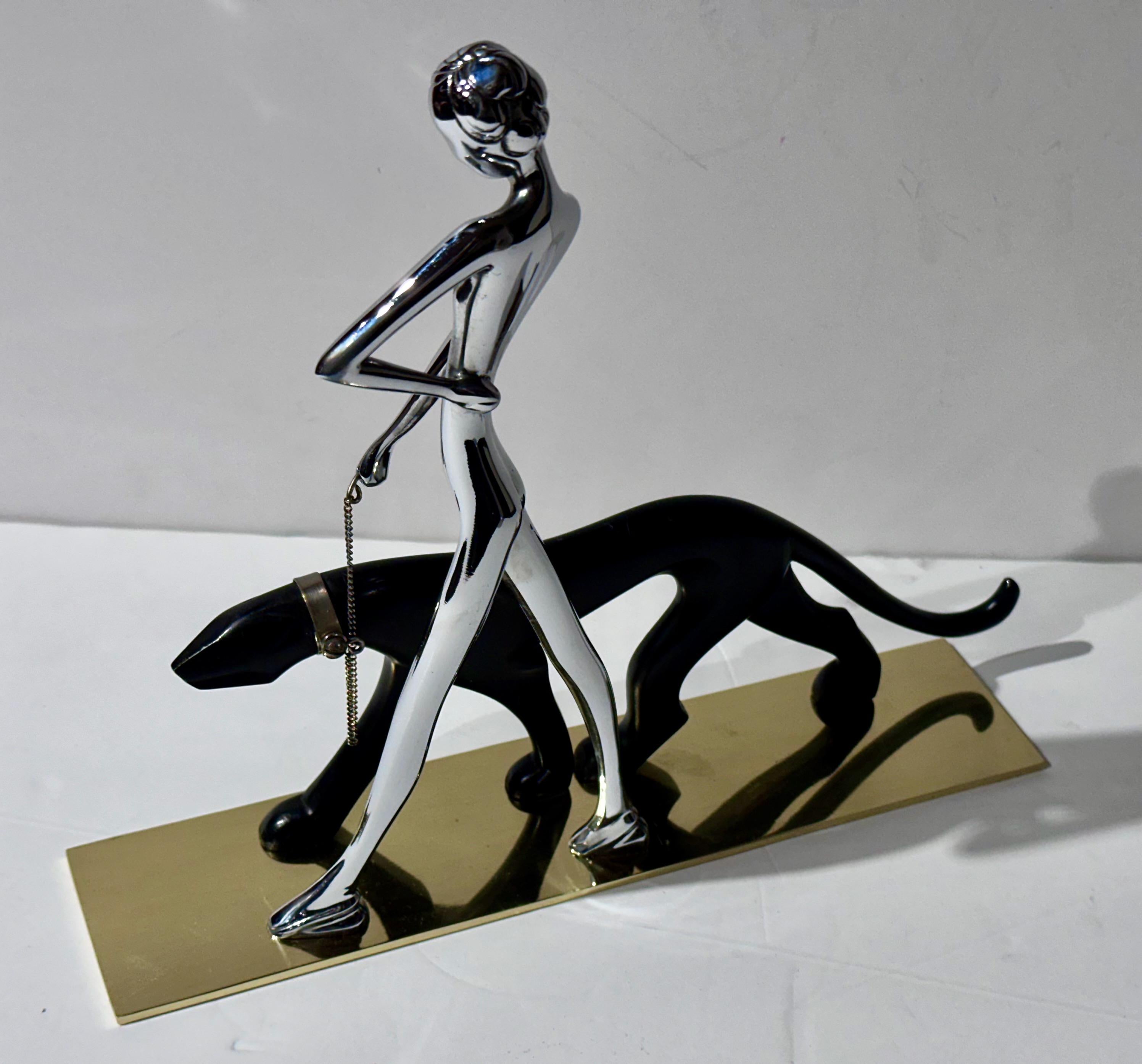 This dynamic sculpture, “Woman Walking Panther,” is a striking example of Art Deco artistry from 1930s Vienna. Crafted by the renowned Austrian sculptor Karl Hagenauer in 1928, this piece captures the essence of the era’s style with its elegant nude
