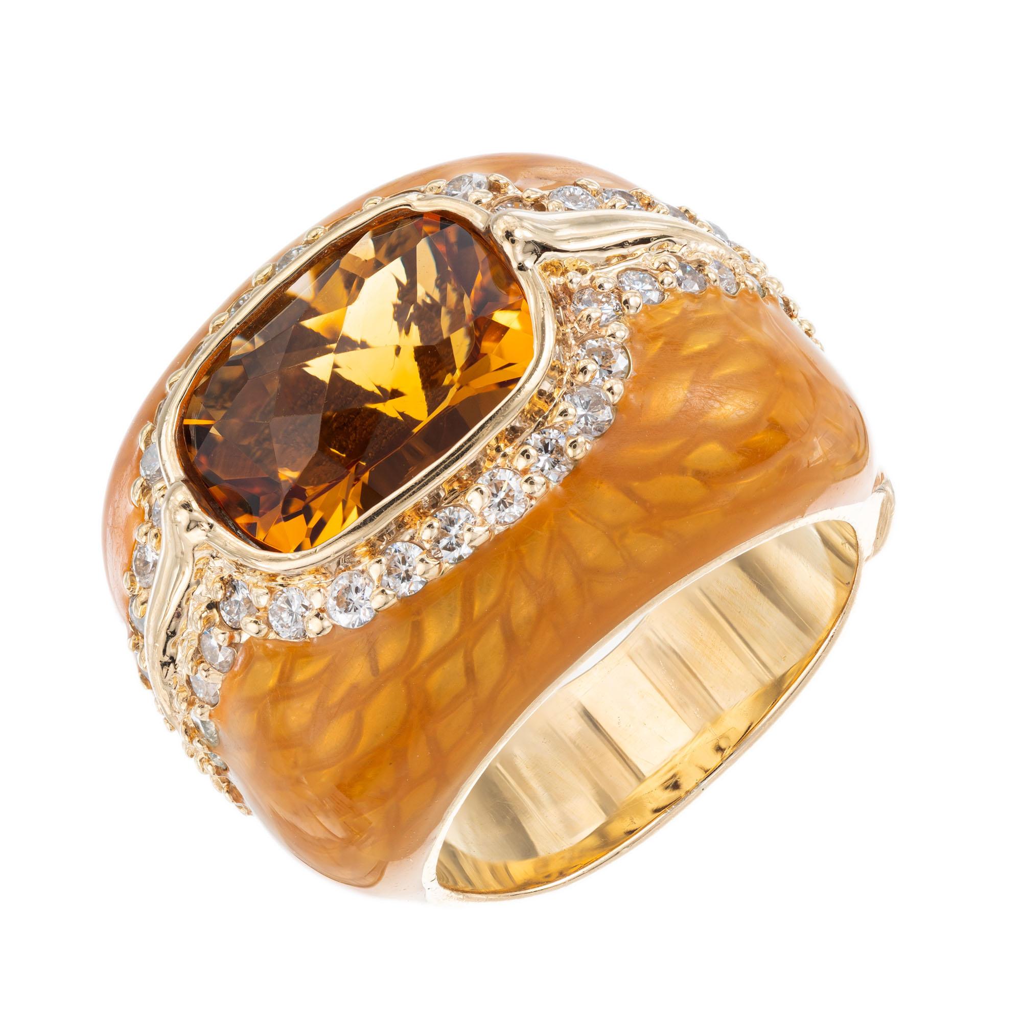 Haggai citrine and diamond cocktail ring. Oval center citrine with a halo of round diamonds in a 14k yellow gold enamel setting. Signed Haggai. Not sizable.

1 Oval citrine 3.00ct. 
44 round diamonds, .44ct. F, VS 
Size 4 - Not sizable
14k Yellow