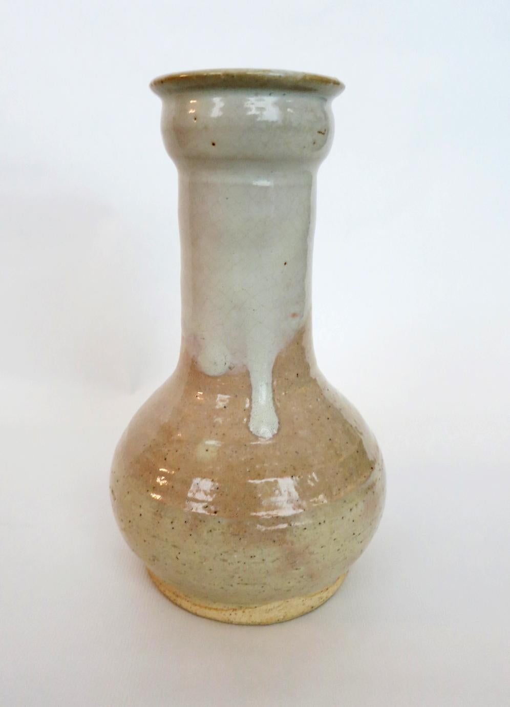 A stoneware vase with white dripping glaze from Hagi by Kyusetsu Miwa X (1895-1981), Showa Period. The vase is in the shape of 