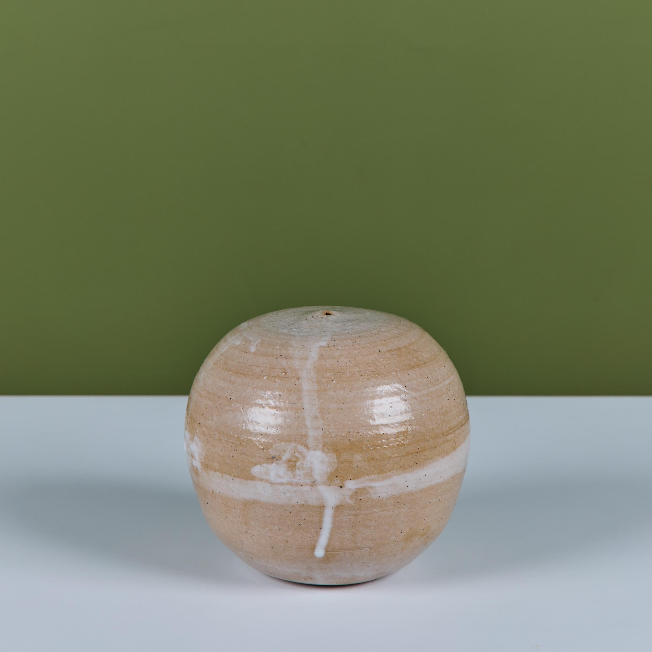 Studio ceramic weed pot in soft peach tones with a cream drop banding at the center.

Dimensions
6.75