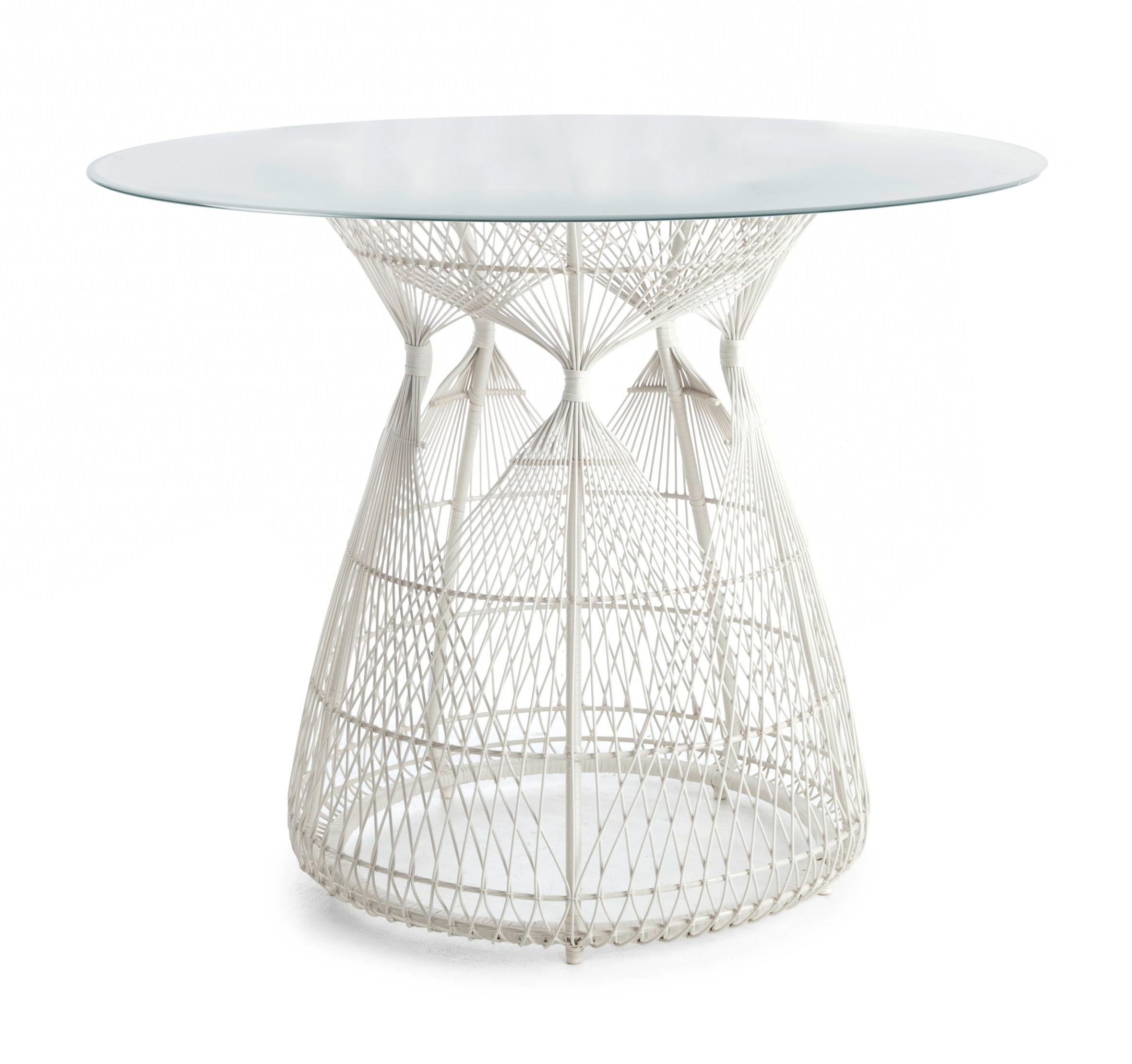 Hagia dining table by Kenneth Cobonpue
Materials: Polyethelene, nylon. Steel. Glass. 
Also available in other colors. 
Dimensions: 
Glass diameter 100cm x height 12mm
Table diameter 61 cm x height 74 cm 

Bask in Hagia’s regal luxury and