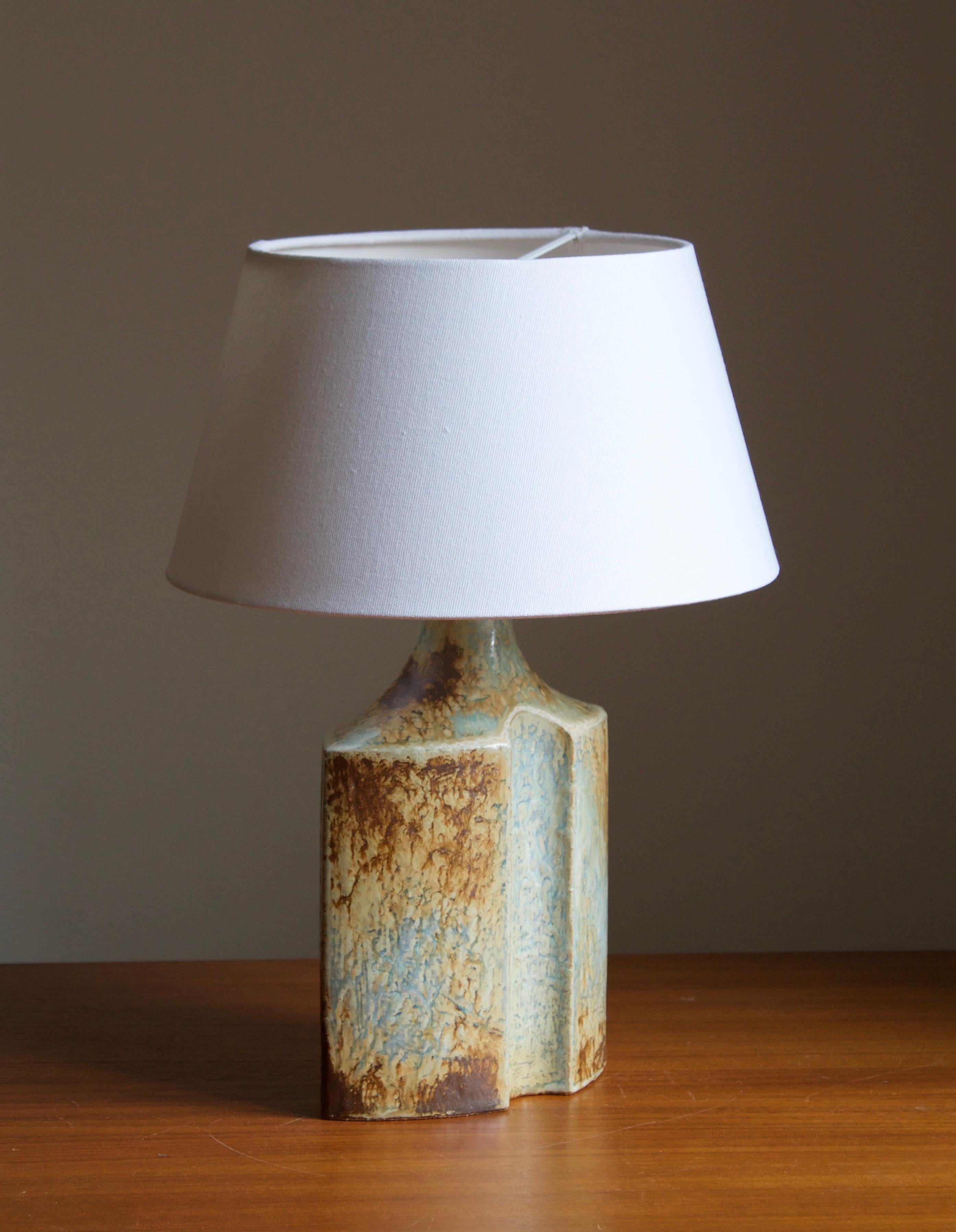 A table lamp produced by Søholm Keramik, located on the island of Bornholm in Denmark. Features a highly artistic glazed decor. 

Sold without lampshade. Stated dimensions exclude the lampshade. Height includes socket.

Other designers of the