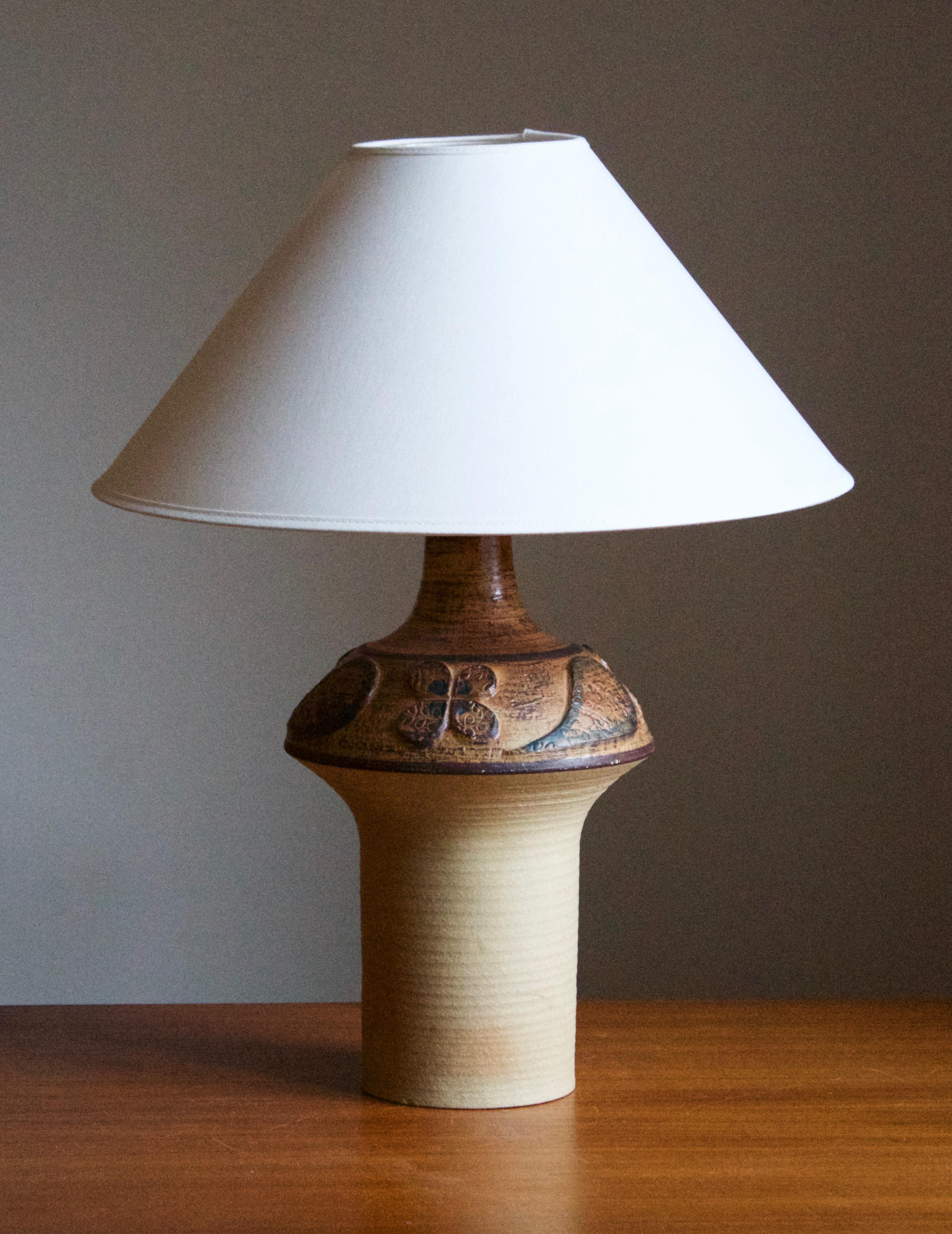 A table lamp produced by Søholm Keramik, located on the island of Bornholm in Denmark. Features a highly artistic glazed decor. 

Sold without lampshade. Stated dimensions exclude the lampshade. Height includes socket.

Other designers of the