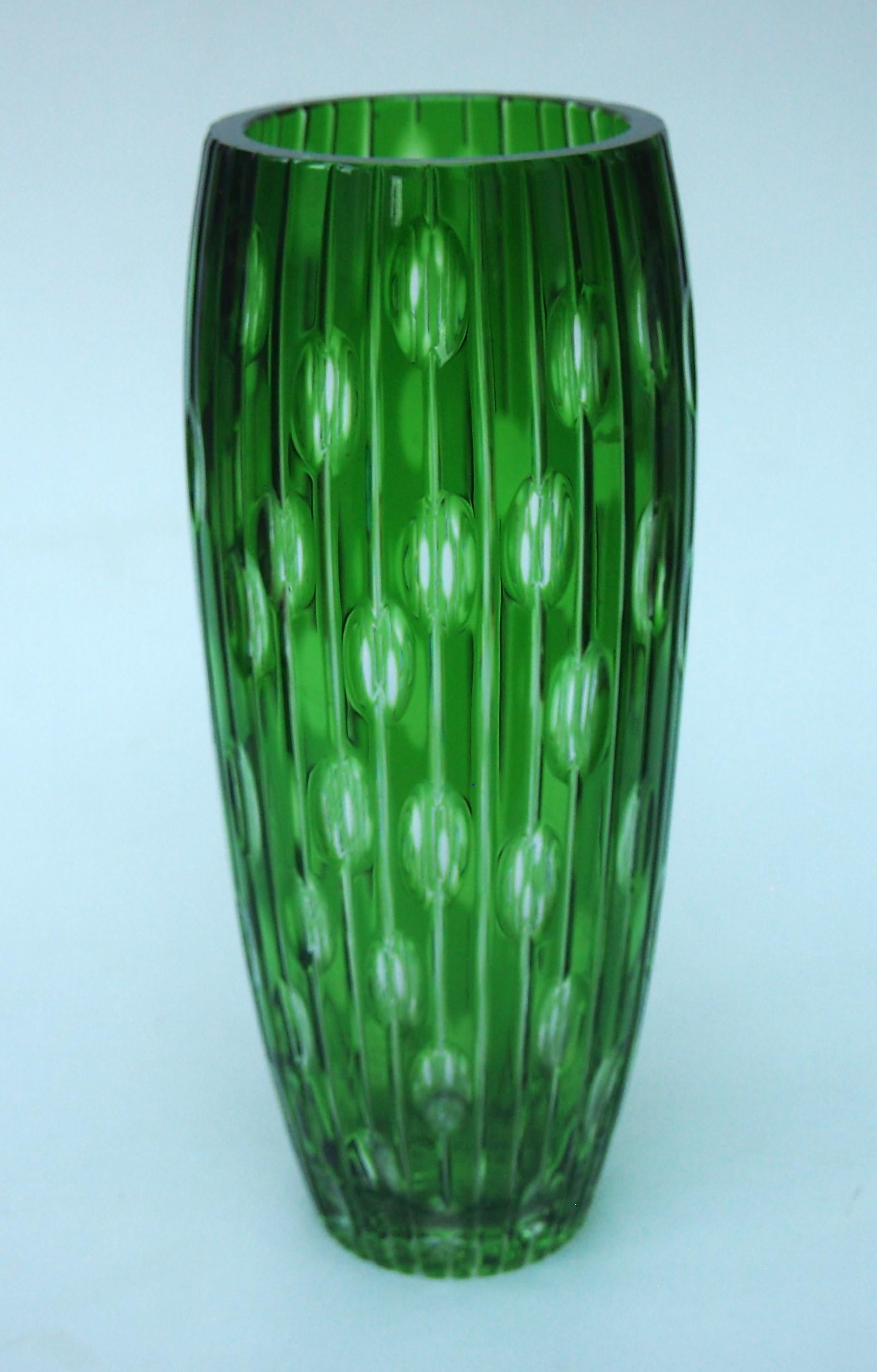 Fabulous crystal green, cut to clear, 1000 eye vase from the Haida region of Czechoslovakia -possibly by either Carl Metzler or Carl Hosch. 1000 eye vases are so called because as you look into each of the dozens of cut 'eye' apertures you can see