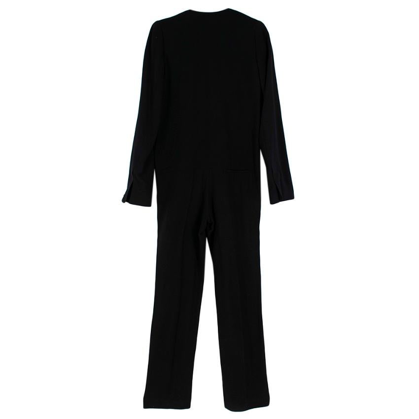 Haider Ackermann - black long sleeve jumpsuit

Deep V neck- slightly padded shoulders - white collar with black trim - chest pocket - back pocket and two front pockets - band around the waist - silk lining 

Please note, these items are pre-owned