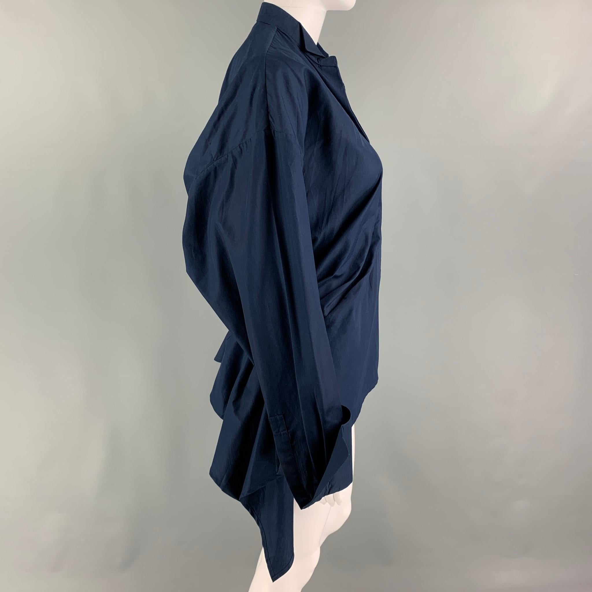 HAIDER ACKERMANN top comes in a navy cotton featuring a peplum design, pleated details, long sleeves, and a hidden placket closure. Made in Belgium.

Excellent Pre-Owned Condition.
Marked: Size tag removed.

Measurements:

Shoulder: 20 in.
Bust: 30