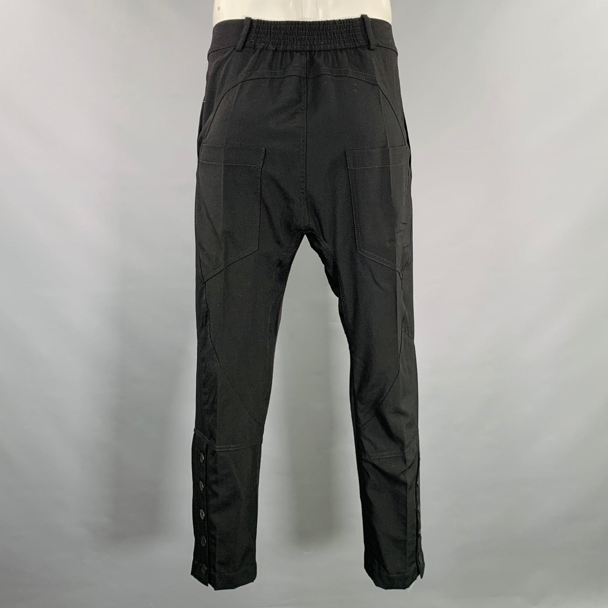 HAIDER ACKERMANN dress pants
in a black wool polyamide blend fabric featuring a drop crotch style, ankle button details, and button fly closure. Made in Portugal.Excellent Pre-Owned Condition. 

Marked:   42 

Measurements: 
  Waist: 34 - 38 inches