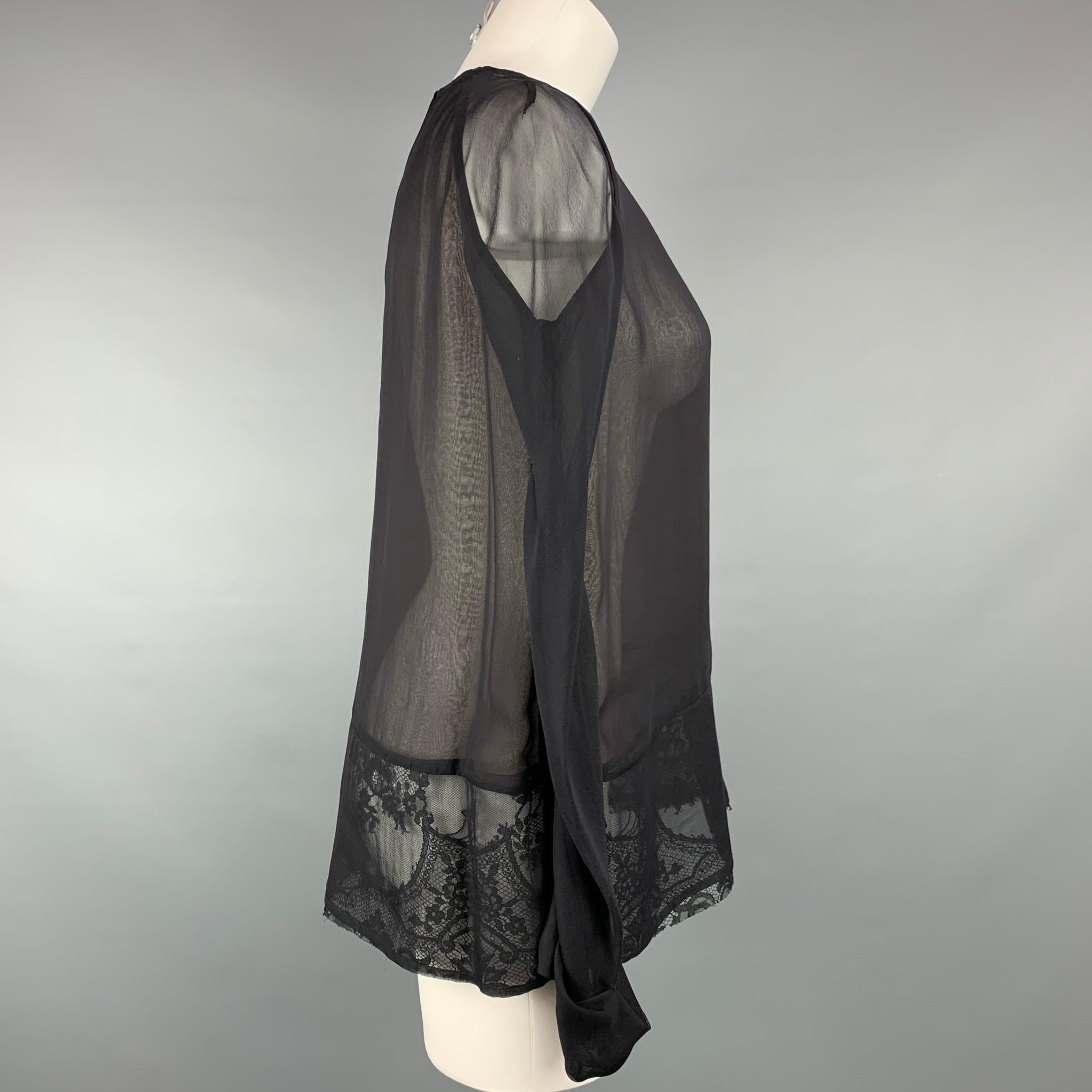 HAIDER ACKERMANN blouse comes in a black & brown silk with a lace panel folded cuffs and a hook & loop closure. Made in Portugal. 

Very Good Pre-Owned Condition.
Marked: 40
Original Retail Price: $1,765.00

Measurements:

Shoulder: 17 in.
Bust: 40