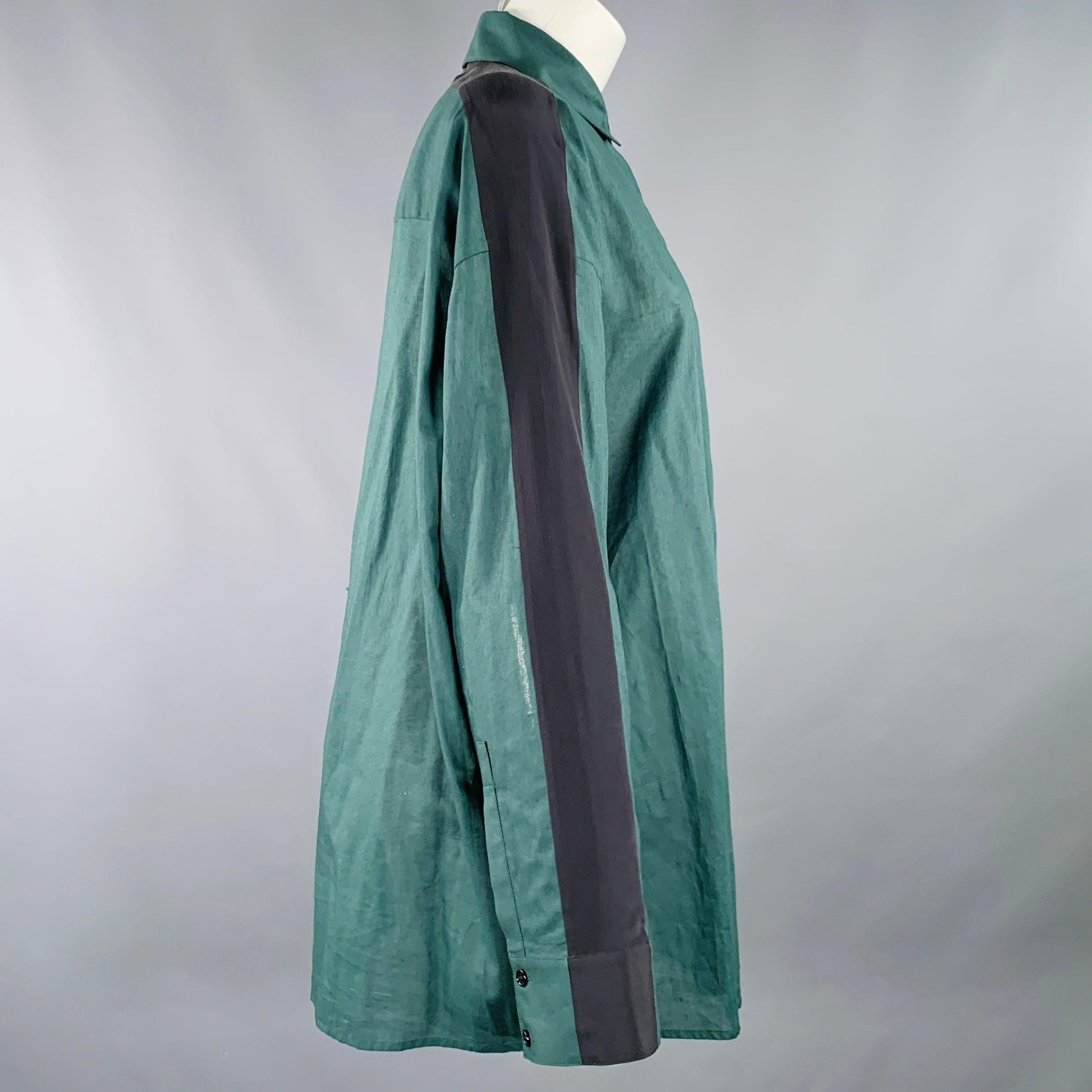 HAIDER ACKERMANN shirt
in a green cotton woven fabric featuring black silk sleeve stripes, oversized fit, and hidden button closure. Excellent Pre-Owned Condition. 

Marked:   IT 36 

Measurements: 
 
Shoulder: 21 inches Bust: 50 inches Sleeve: 21.5