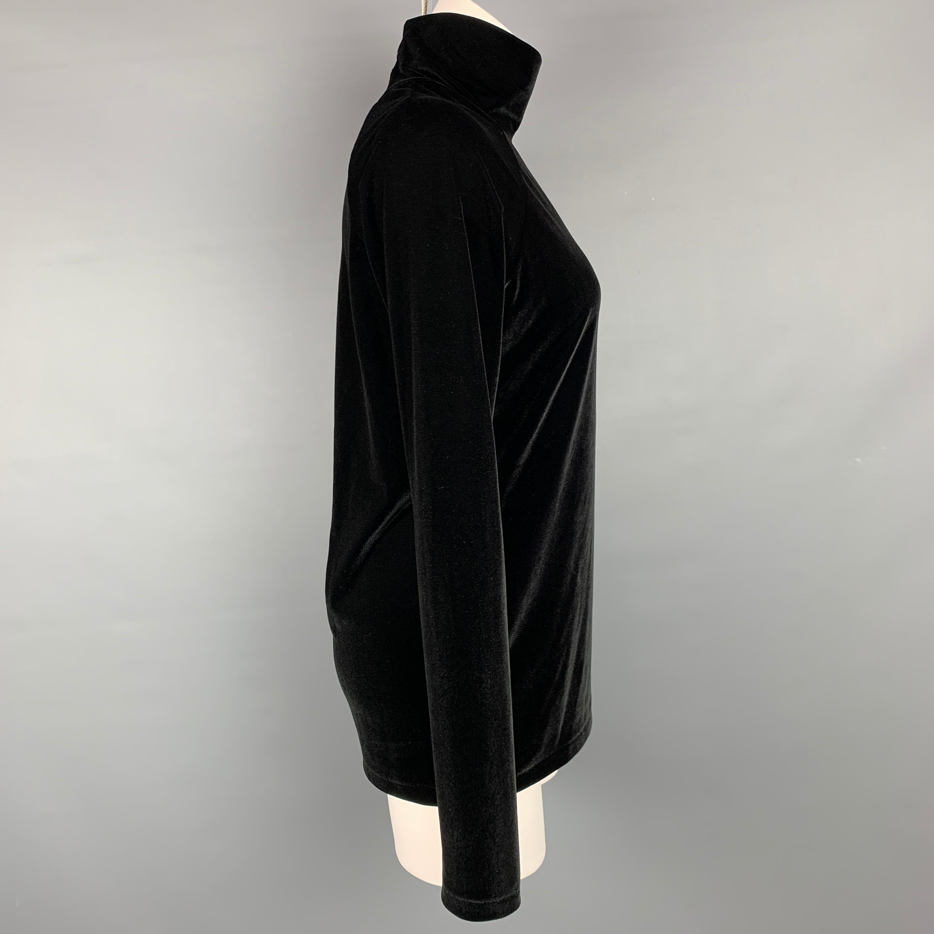 HAIDER ACKERMANN pullover comes in a black polyester featuring a turtleneck and a back zipper closure. Made in Portugal.

Very Good Pre-Owned Condition.
Marked: L

Measurements:

Shoulder: 17 in.
Bust: 38 in.
Sleeve: 26 in.
Length: 26.5 in. 