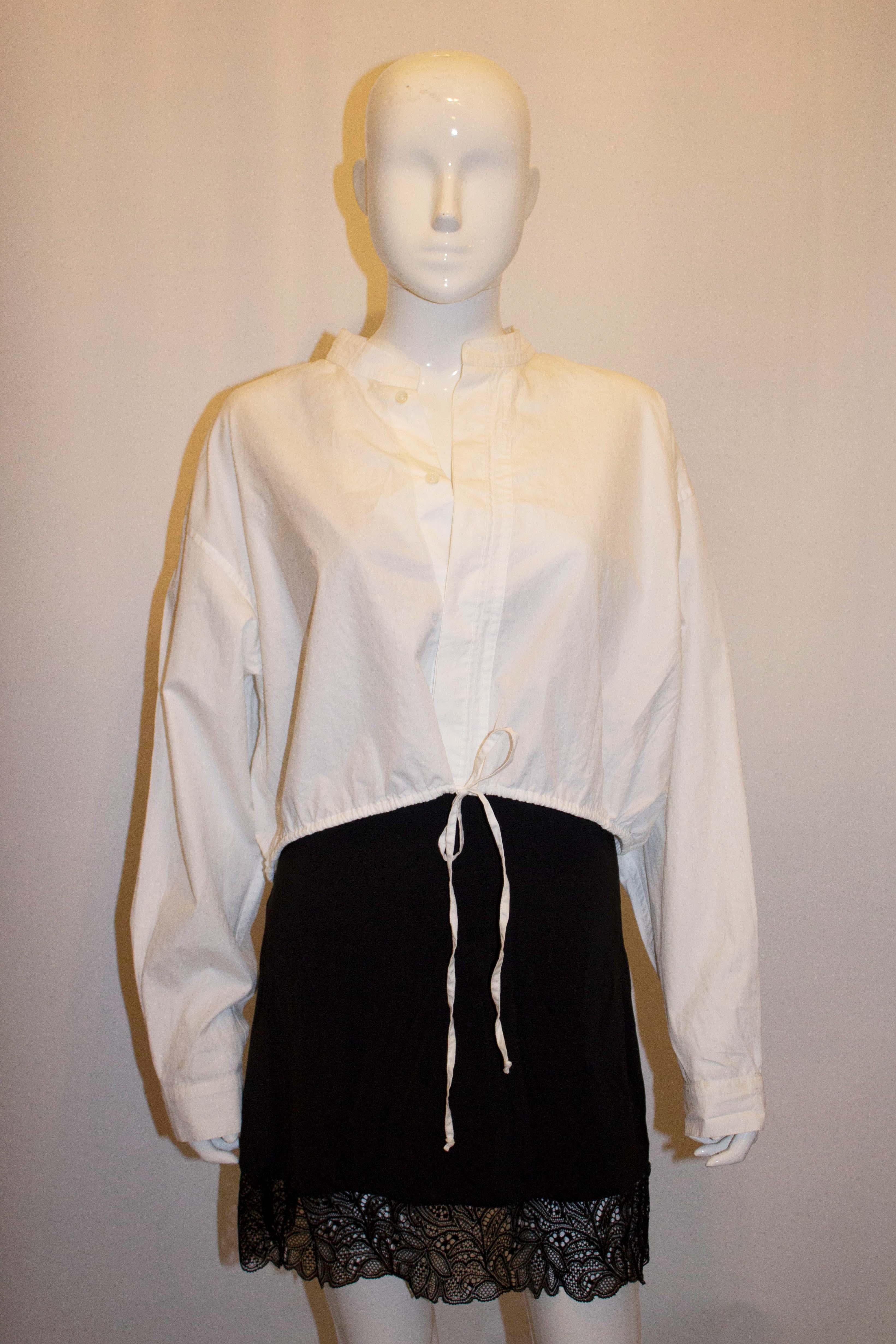 A chic cotton top by Haider Ackermann. Made in white cotton , the top has a drawstring waist, stand up collar and hidden button opening. Size 38, made in Belgium
Measurements: Bust up to 42'', length 13''