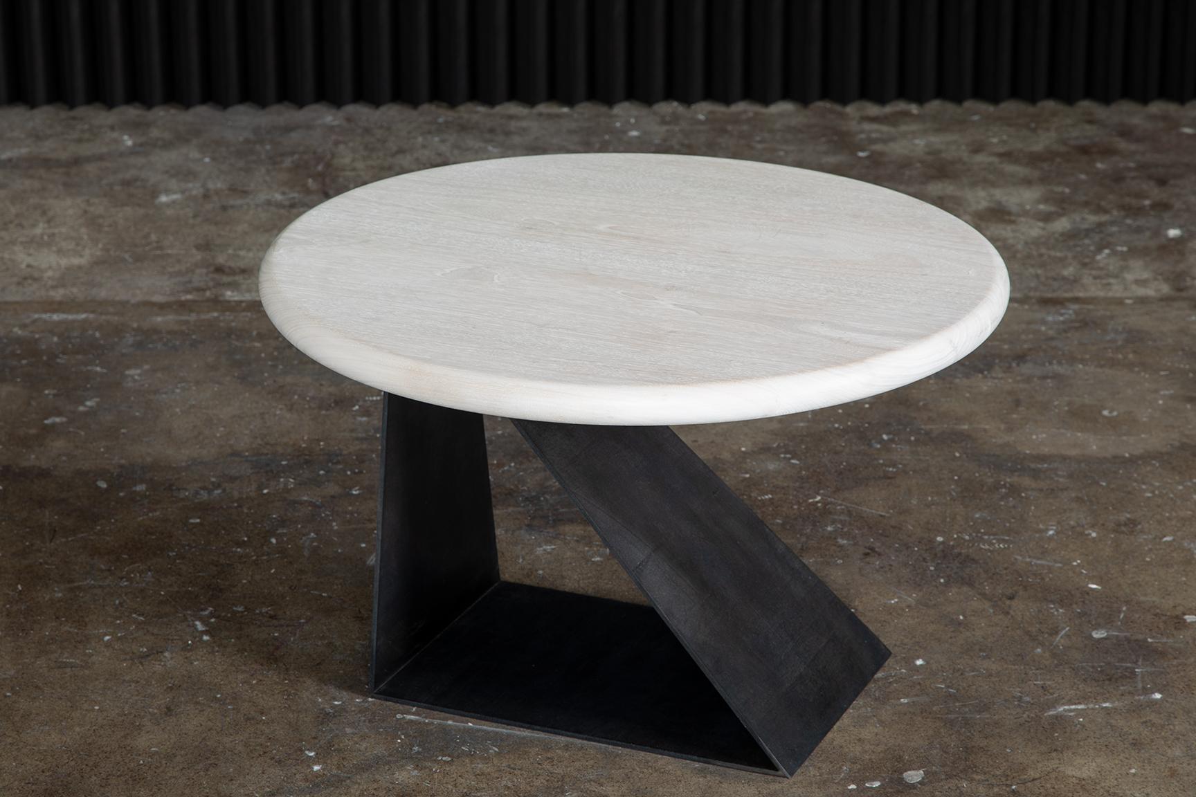 Form and function. The Haider Side Table takes cues from Haider Ackerman's designs—sharp edges made possible by darts and unexpected seaming, an edginess that is emulated in the base of this piece. Harsh lines and clean edges offer a beautiful