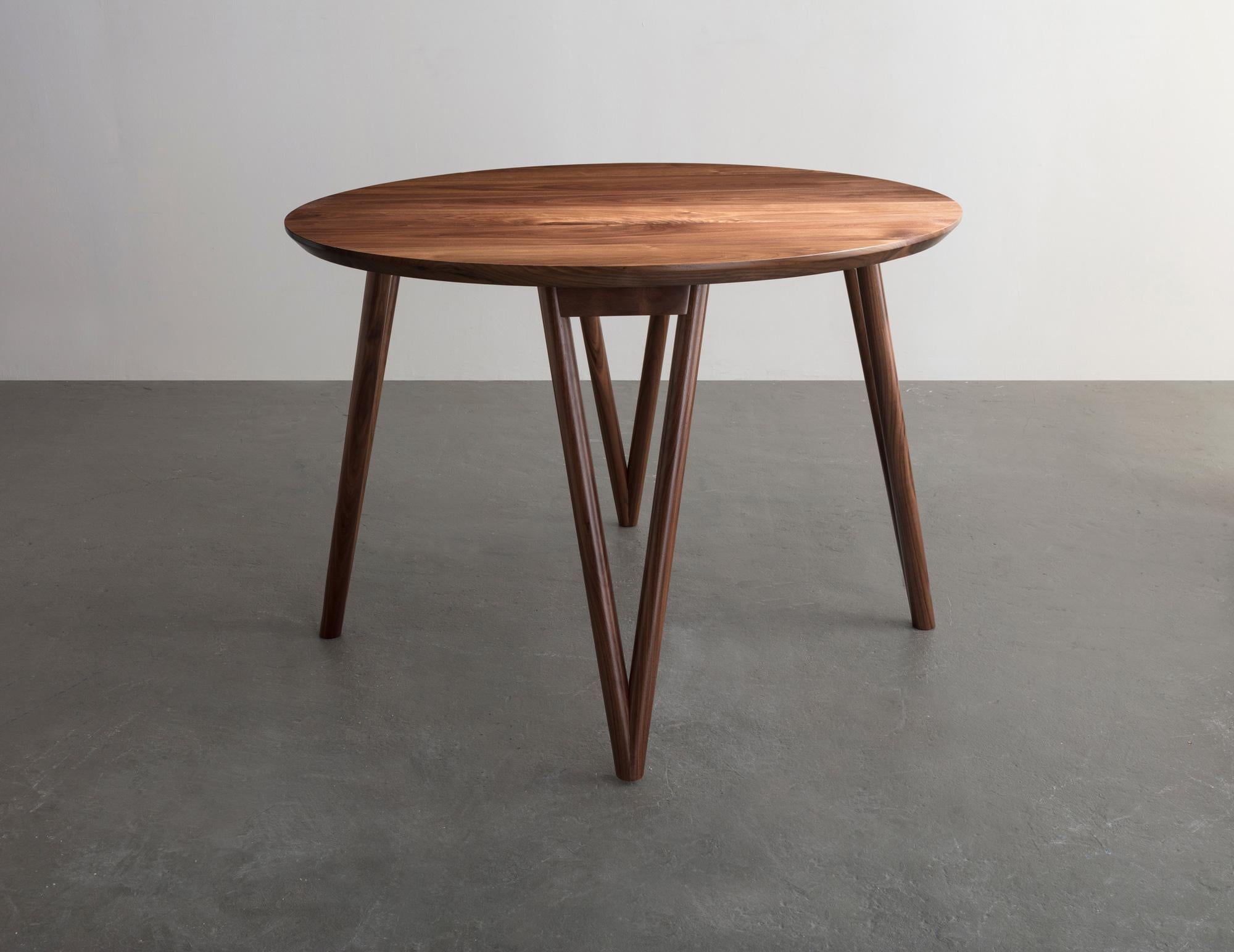 The Hair Pin table uses a solid wood interpretation of a classic leg giving new style to this seemingly traditional support.

Shown in walnut and available in ash, maple, or white oak. 

