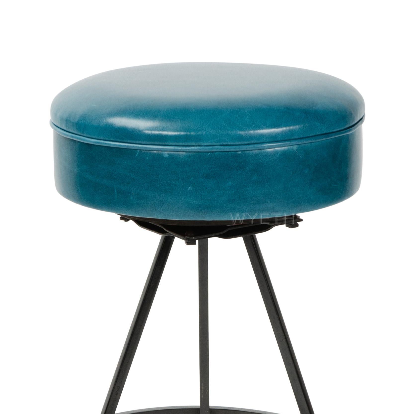 A patinated steel barstool with newly upholstered aqua blue leather swivel seat on splayed, square-rod hairpin legs supporting a ring footrest. (13