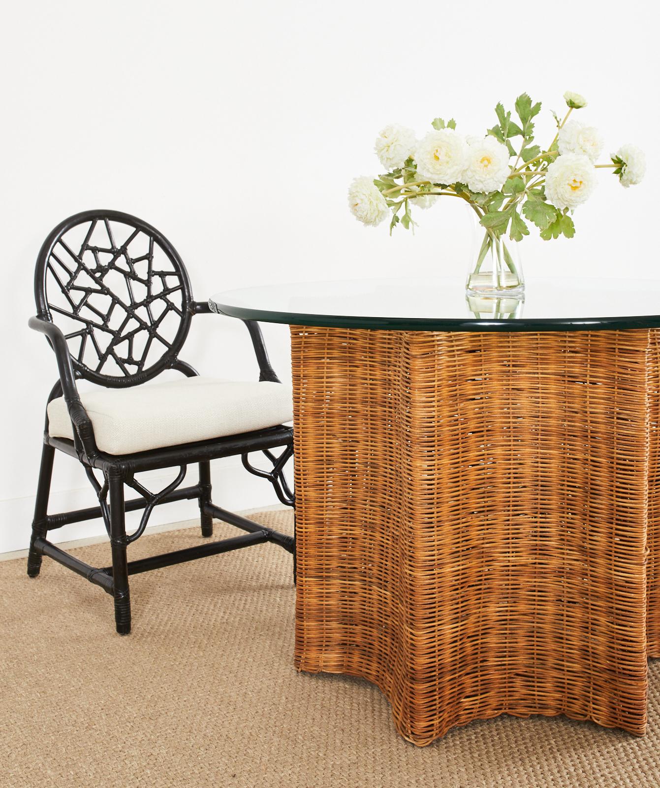 Whimsical organic modern dining table or center table crafted from woven wicker rattan in the form of a starfish pedestal. Made in Haiti from a metal frame covered with woven wicker rattan. The six-pointed star top is centered by a concentric circle