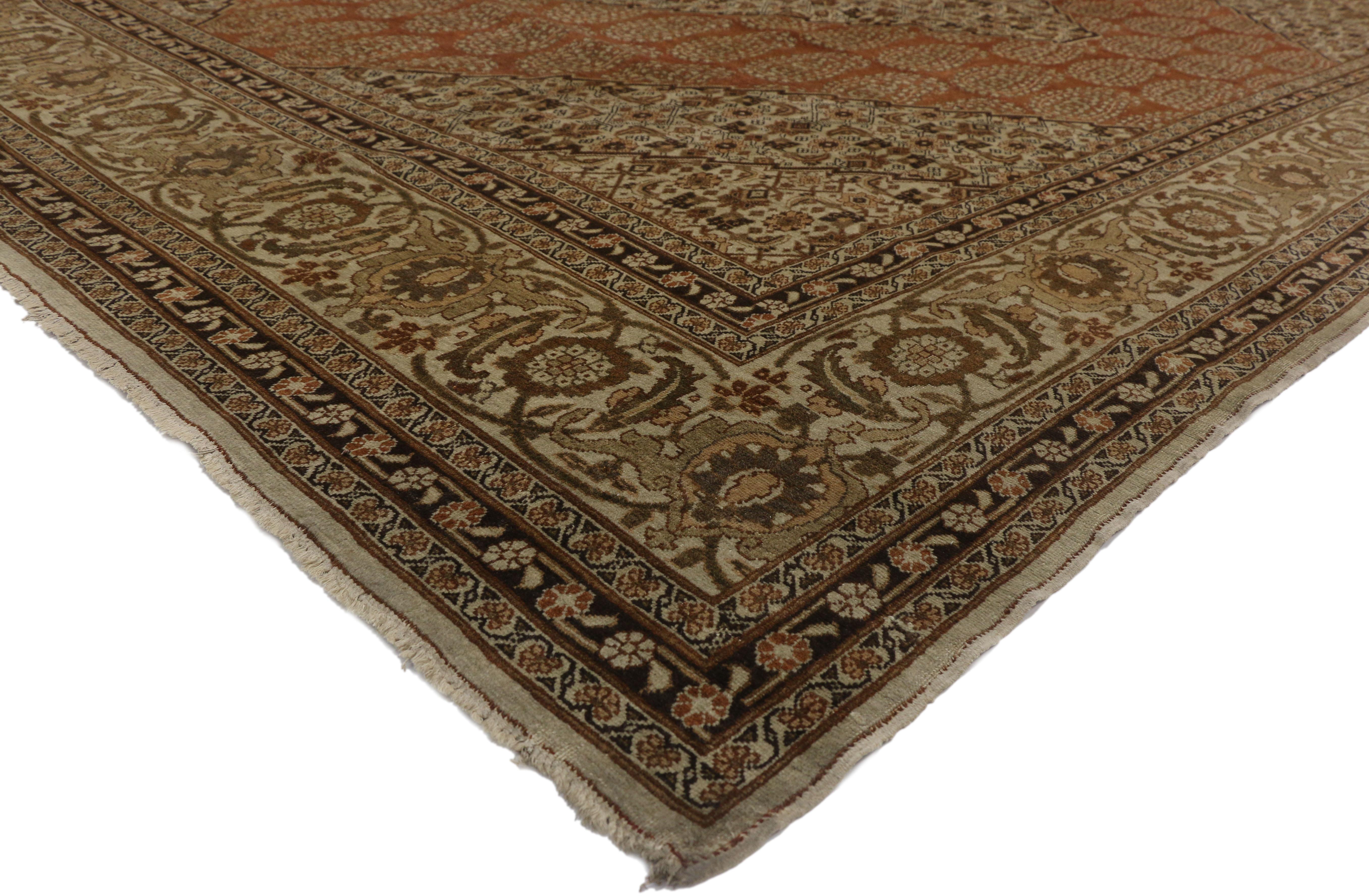 73538, Haji Khalili antique Persian Tabriz rug with Modern Rustic style. This hand knotted wool Haji Khalili antique Persian Tabriz rug features a large stepped concentric hexagonal medallion filled Herati motifs. It is surrounded by a burnt