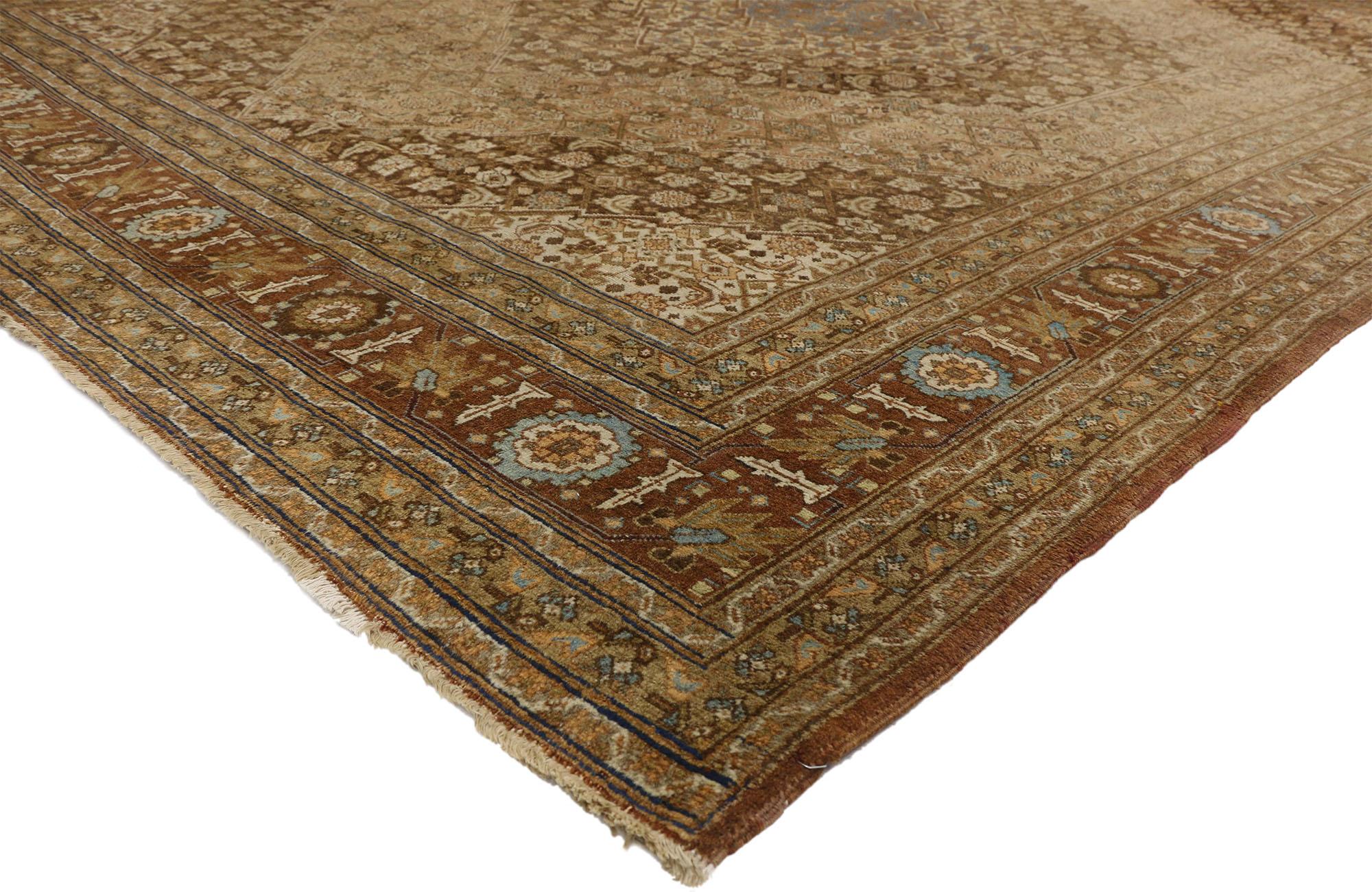 74327 Haji Khalili Antique Persian Tabriz rug with Warm, Industrial style. This hand-knotted wool Haji Khalili distressed antique Persian Tabriz rug features a series of four serrated hexagonal medallions centered on an abrashed field. The