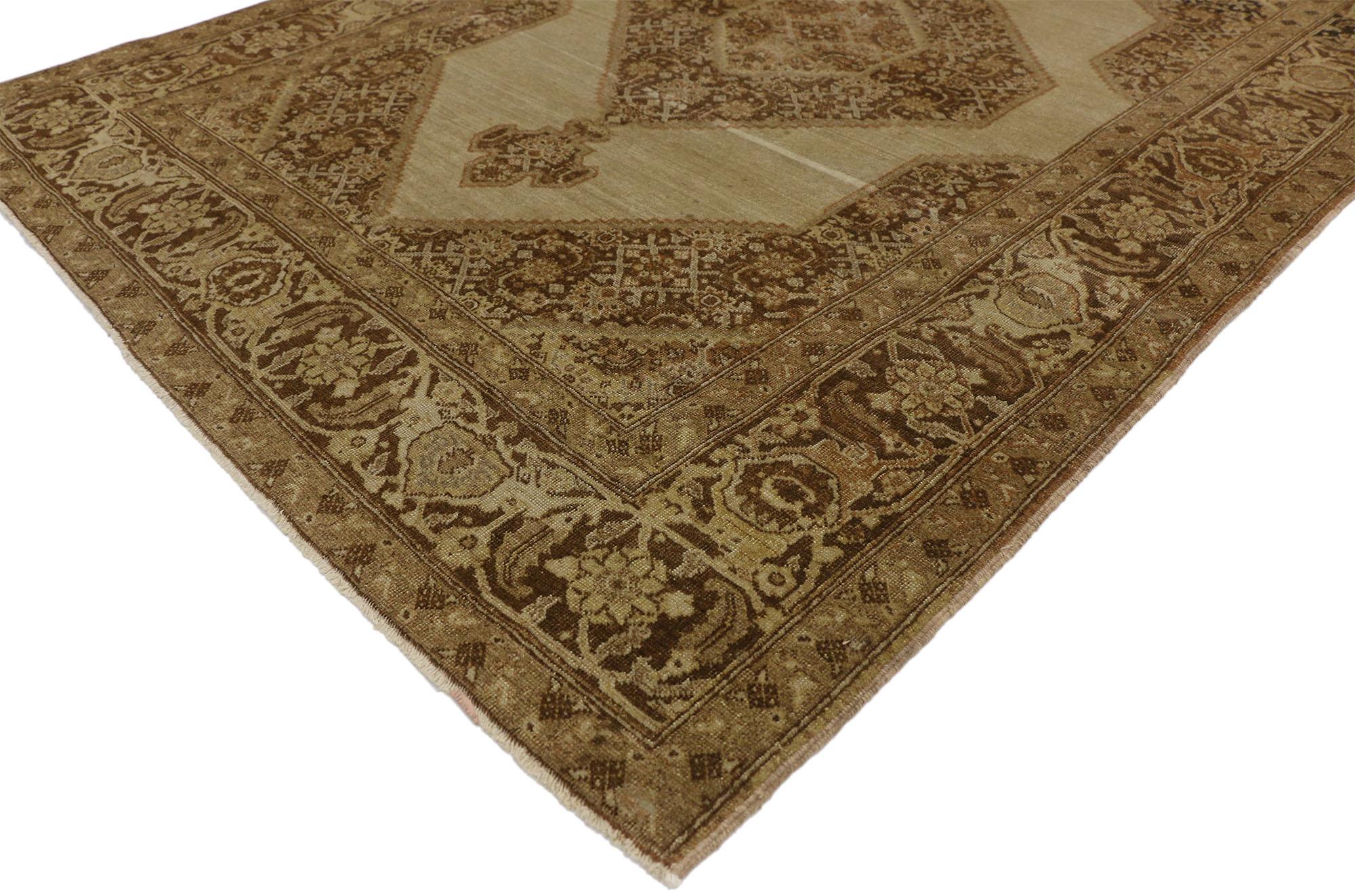 50531 Haji Khalili Antique Persian Tabriz rug with Warm, Industrial style. This hand-knotted wool Haji Khalili antique Persian Tabriz rug features a large serrated hexagonal medallion anchored with pendants centered on an abrashed beige field. The