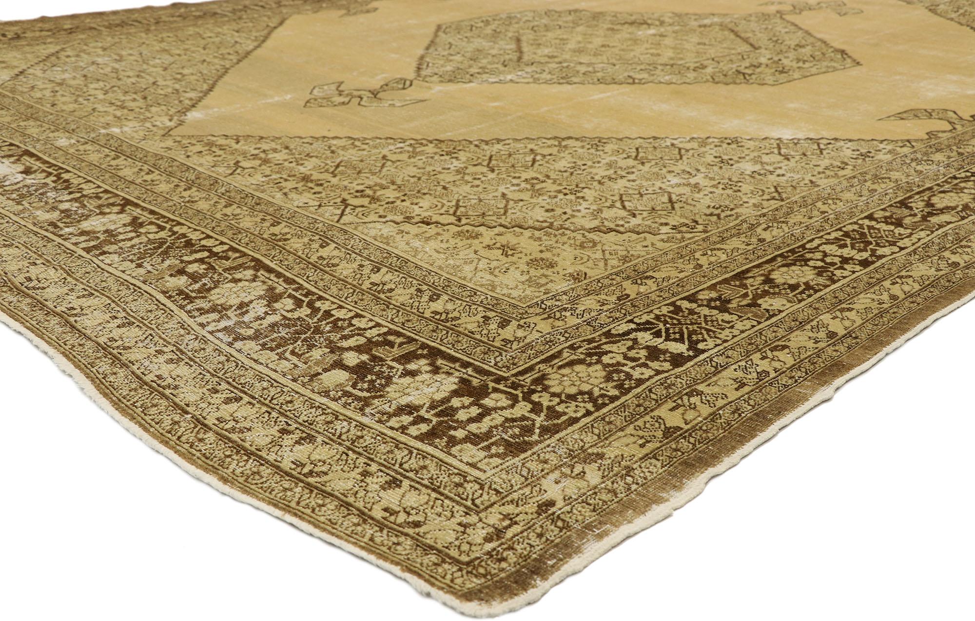 74846 Haji Khalili Distressed Antique Persian Tabriz Rug with Warm, Industrial Style. This hand-knotted wool Haji Khalili distressed antique Persian Tabriz rug features a large serrated hexagonal medallion anchored with pendants centered on an open