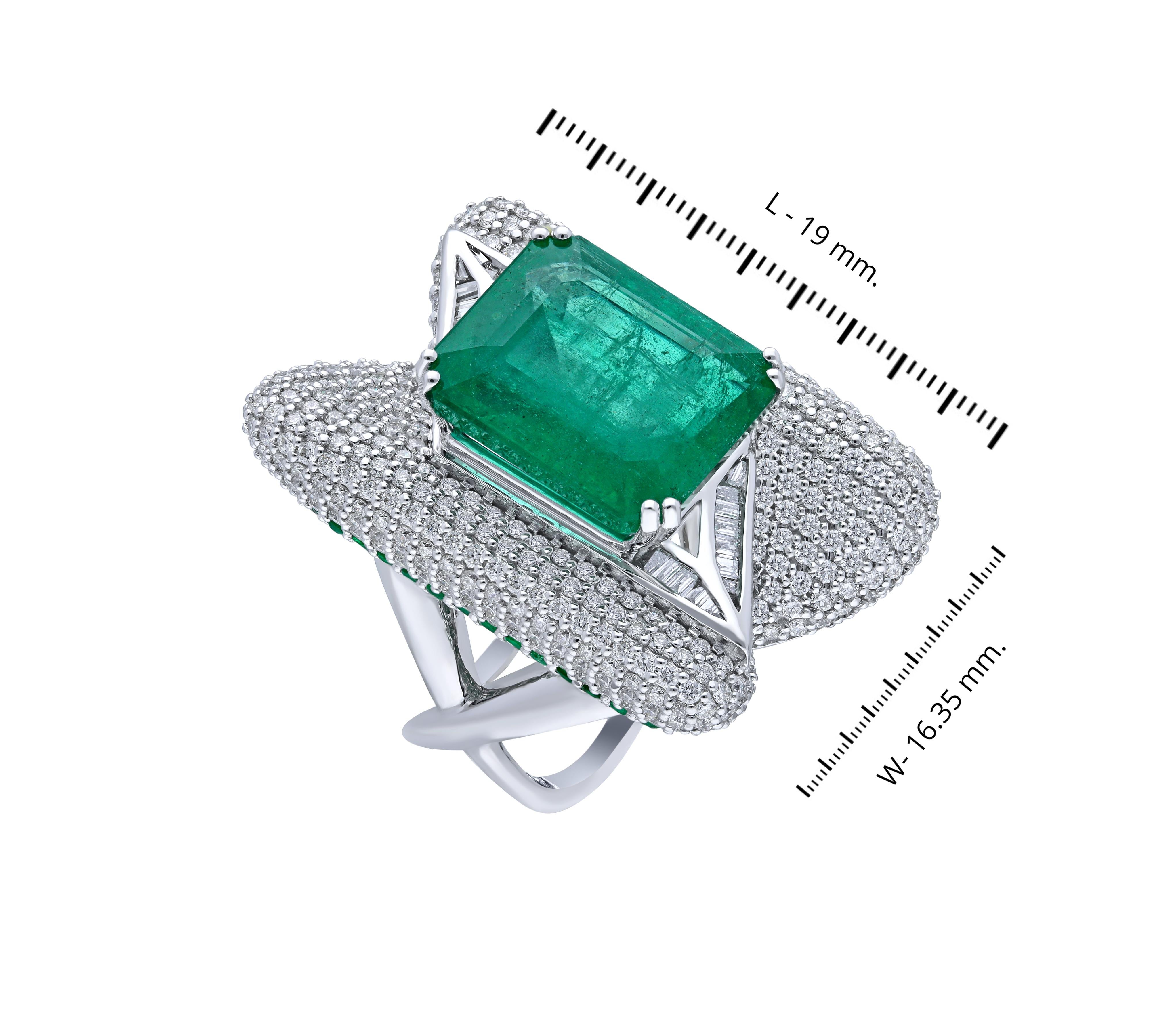  A collectors Multidimensional cocktail ring with a Zambian emerald (10.48 cts) set in a valley of pave diamonds on either side with baguette diamonds below. On the outer sections tsavorite garnets (check the tsavorites or emerald) are paved down as