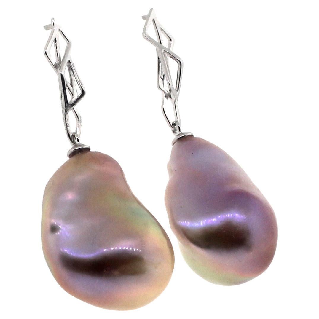 Hakimoto By Jewel Of Ocean
Natural Color Metallic Baroque Pearl Earrings.
18K White Gold
Total item weight 12.8 grams
18-23mm Fancy Metallic Natural color Baroque Cultured Pearls
Hue: Pinkish Purple with Pink and green Overtone
Metal Type: 18K white