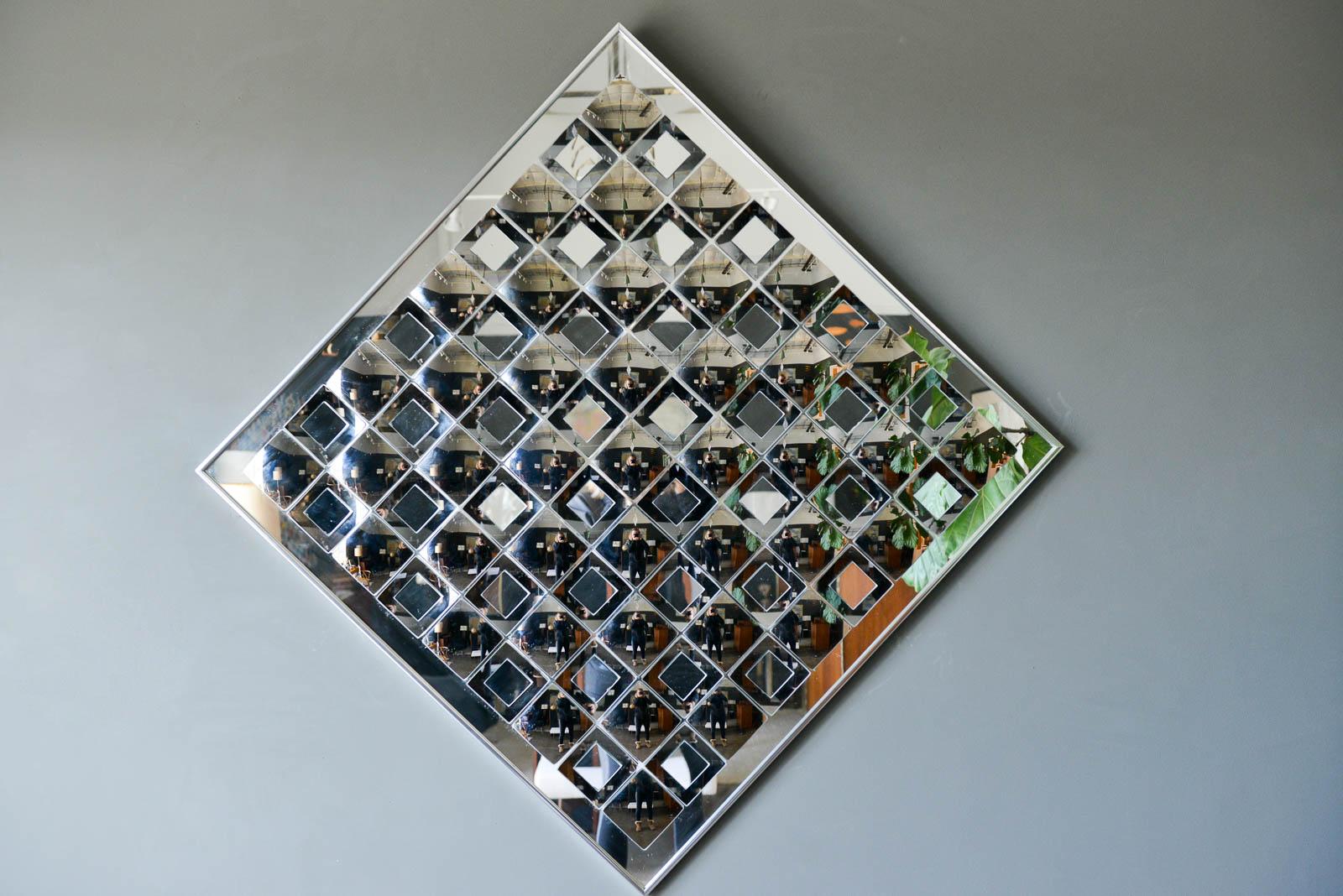 Hal Bienenfeld decorative op art wall mirror, circa 1970. Excellent original condition, signed on reverse this beautiful large mirror is wired to hang at the diagonal, however it can be adjusted to hang square as well. No broken pieces, all mirrors