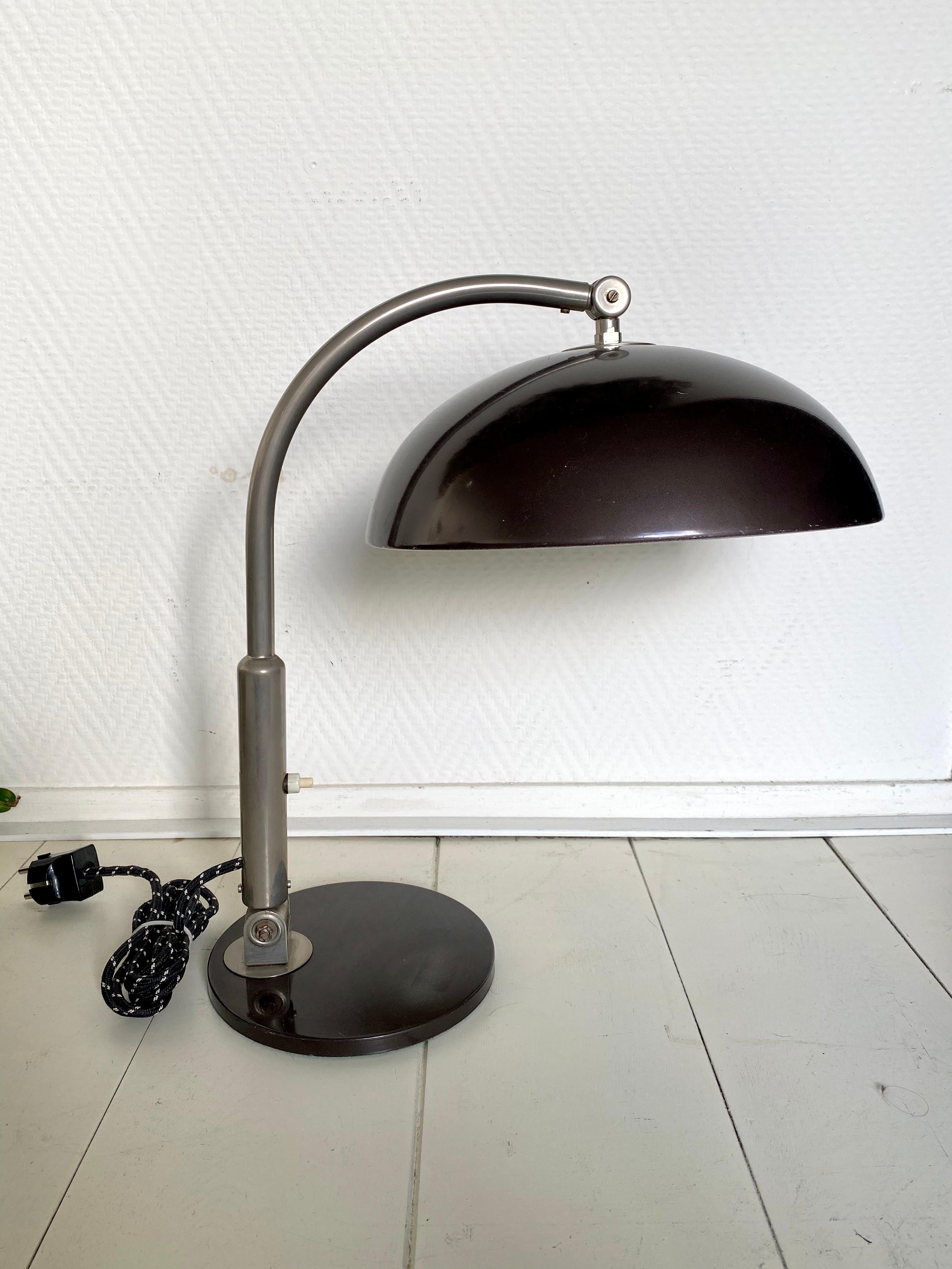 Popular lamp which was designed by Busquet and manufactured by Hala in Holland, circa 1960s. This piece features a dark brown shade and base. It can be positioned in different ways. Remains in good functional condition with some scratches to the