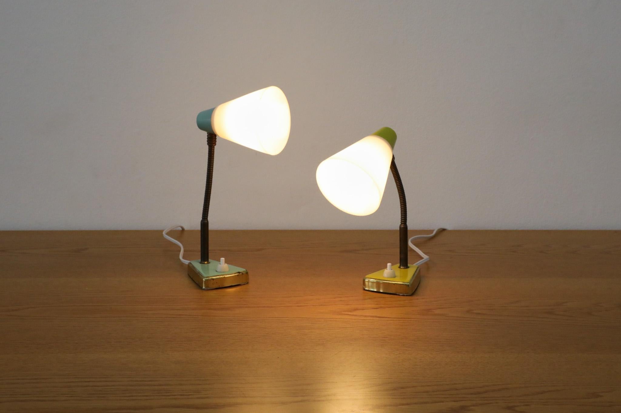 Mid-Century Hala style table or wall lamp in turquoise enameled metal and brass with plastic cone shade. The base has key slot hardware for wall mount. In original condition with visible scratching and brass loss to base as well as a lovely patina.