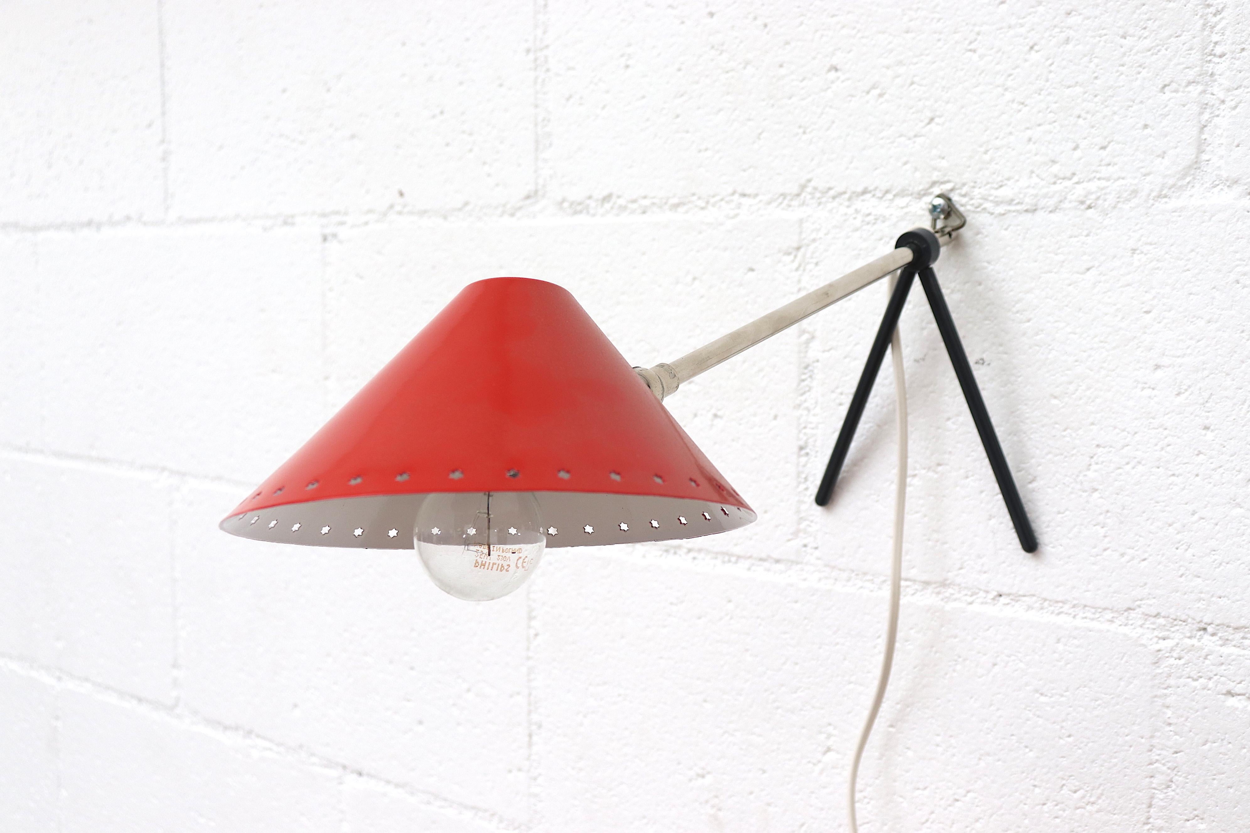 Hala Zeist red enameled metal table or wall lamp with pinocchio shade. Versatile small lamps that function as both table lamp and wall lamp. Great as bedside lamps. Priced individually. In original condition with wear consistent with age and use.