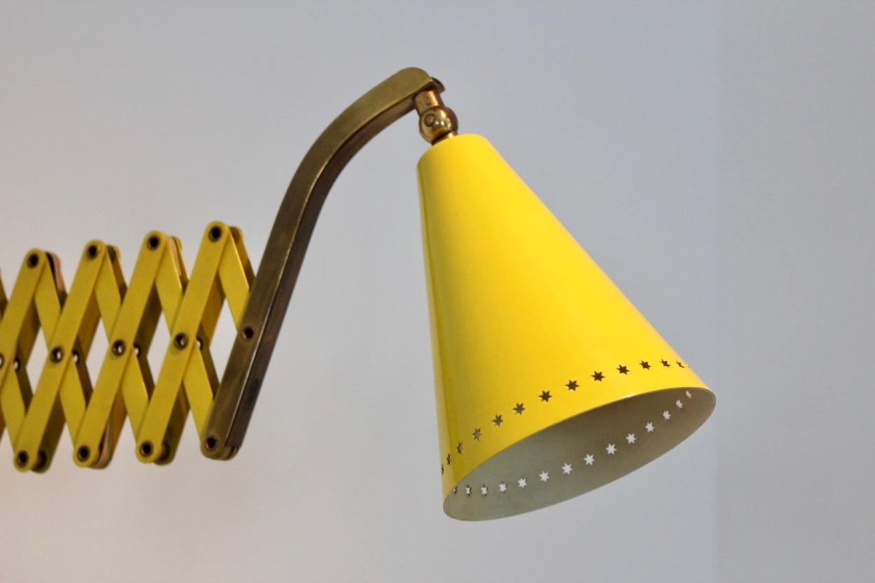 Beautiful and very rare scissor wall lamp designed in the 1950s by H.Th.J.A. Busquet for Hala Zeist the Netherlands. Elegant lacquered yellow metal frame stunning brass arm and extra brass accents. The shades are decorated with a beautiful