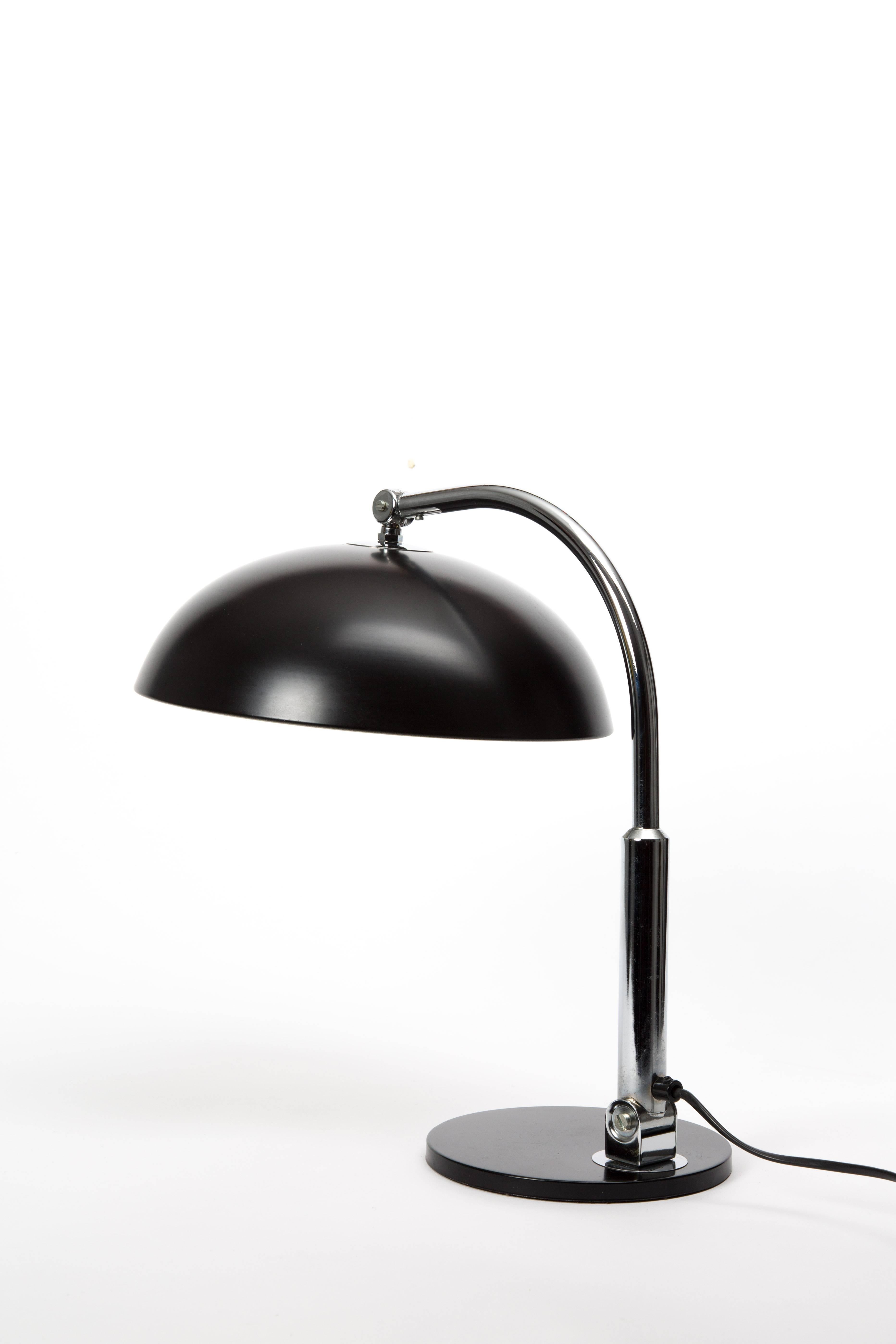 Hala Zeist. Table lamp by J.Busquet. Black painted hat. chrome-plated frame on heavy black foot. Many constellations are possible to get the best light.
   
