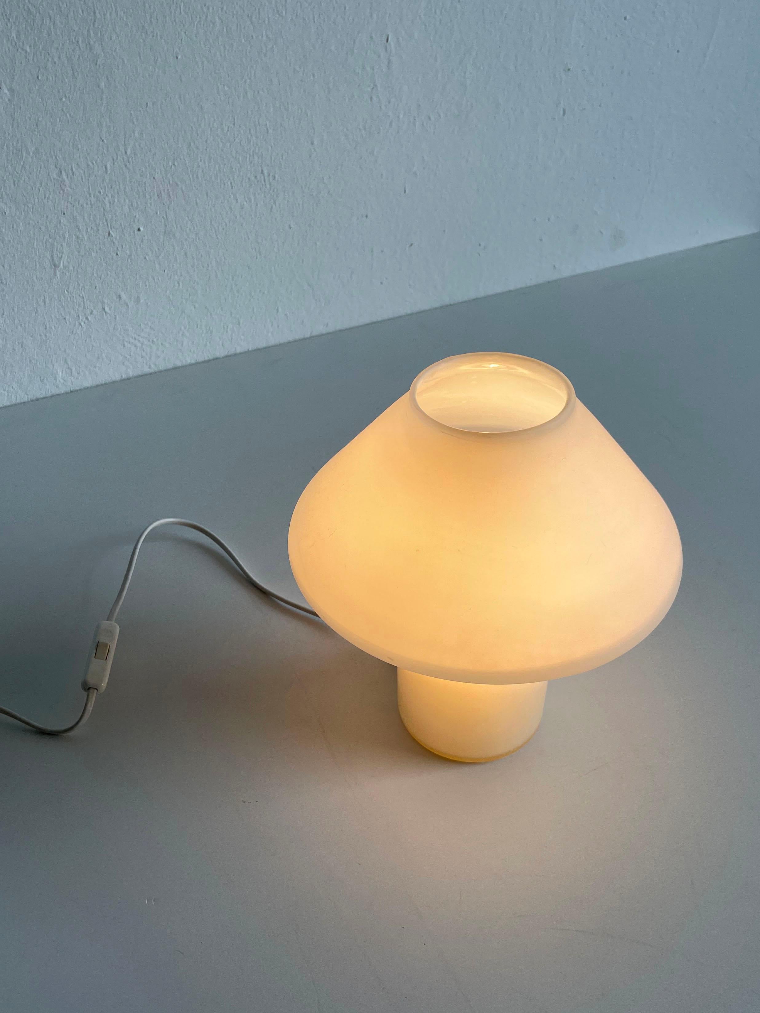 1970s white satin glass mushroom table lamp designed by the Dutch lighting manufacturer Hala Zeist.
The lamp has a mushroom-shape top design with a cylindrical base.

The lamp is unmarked.

It has one E14 lamp socket and an European 2-pin