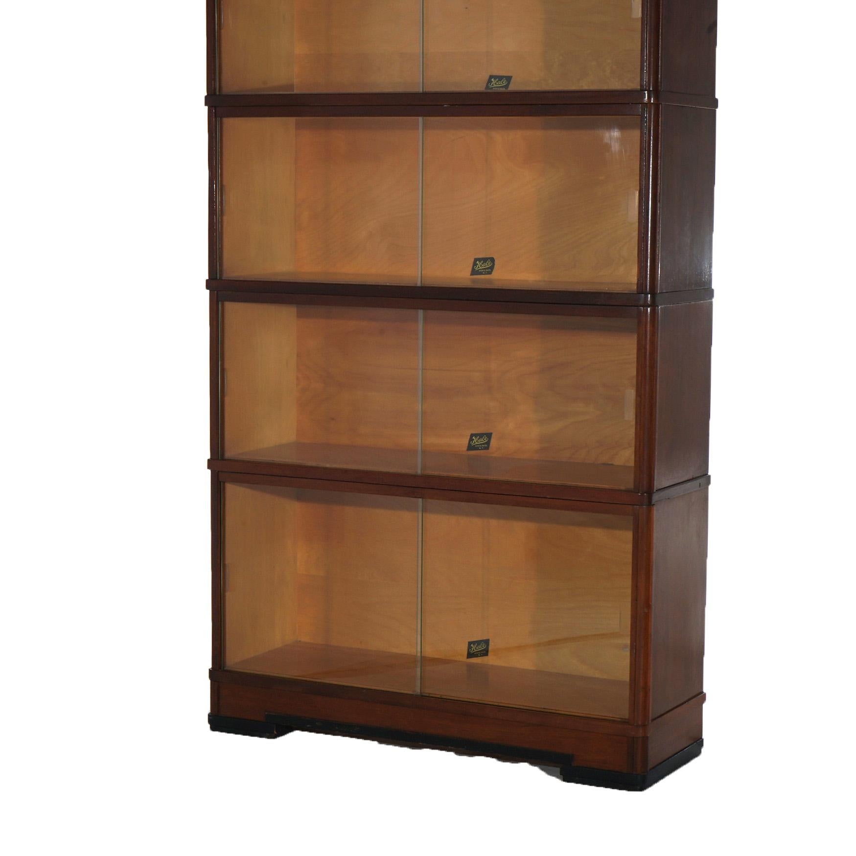 ***Ask About Reduced In-House Delivery Rates - Reliable Professional Service & Fully Insured***
An antique Art Deco barrister bookcase by Hale offers mahogany construction with four stacks, each having pullout glass doors, maker label as