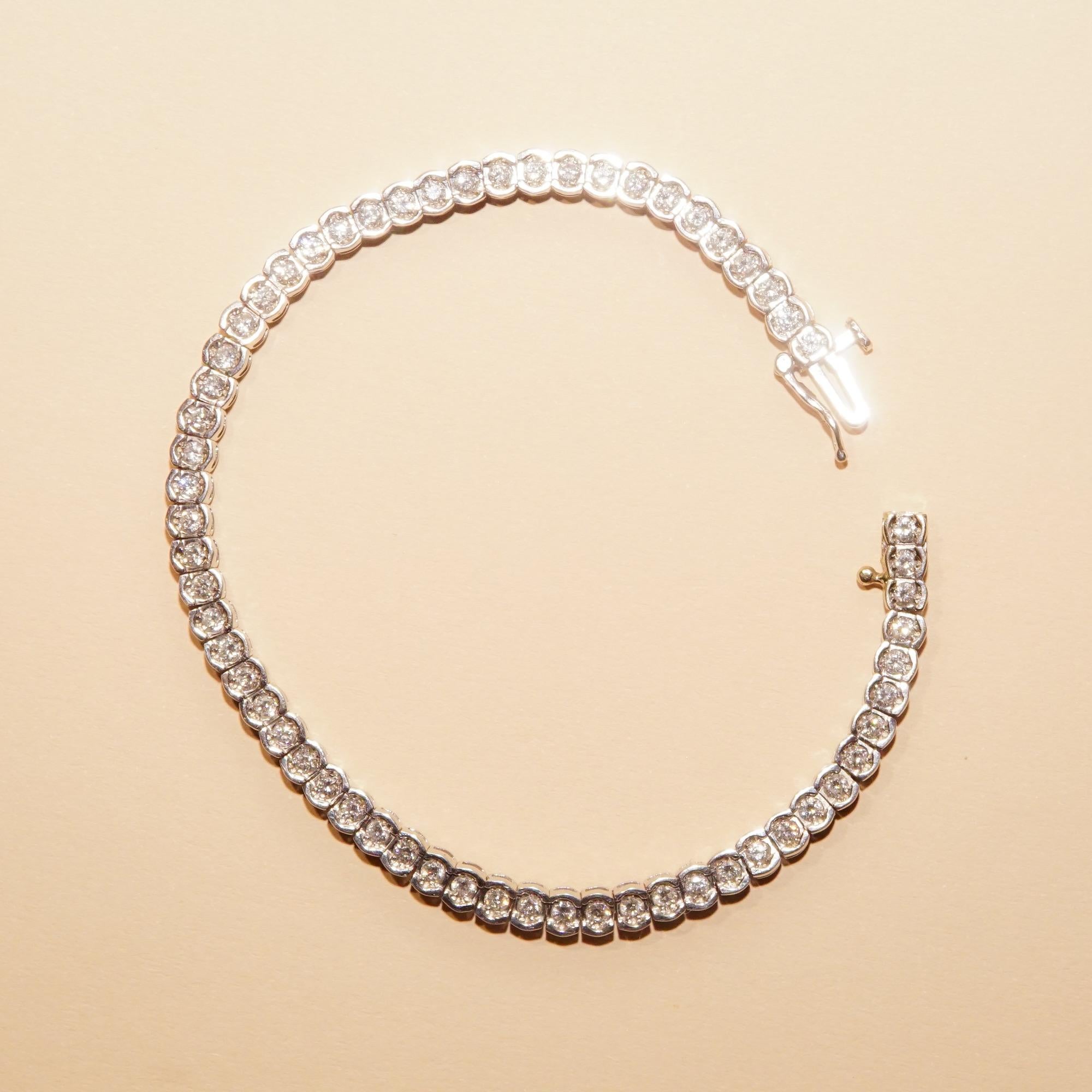 A modern take on a traditional diamond tennis bracelet. Crafted in 14k white gold with 61 brilliant diamonds. Definitely a great gift for a loved on this holiday season!

Features a sleek articulated ribbon of white half-bezel links each set with a