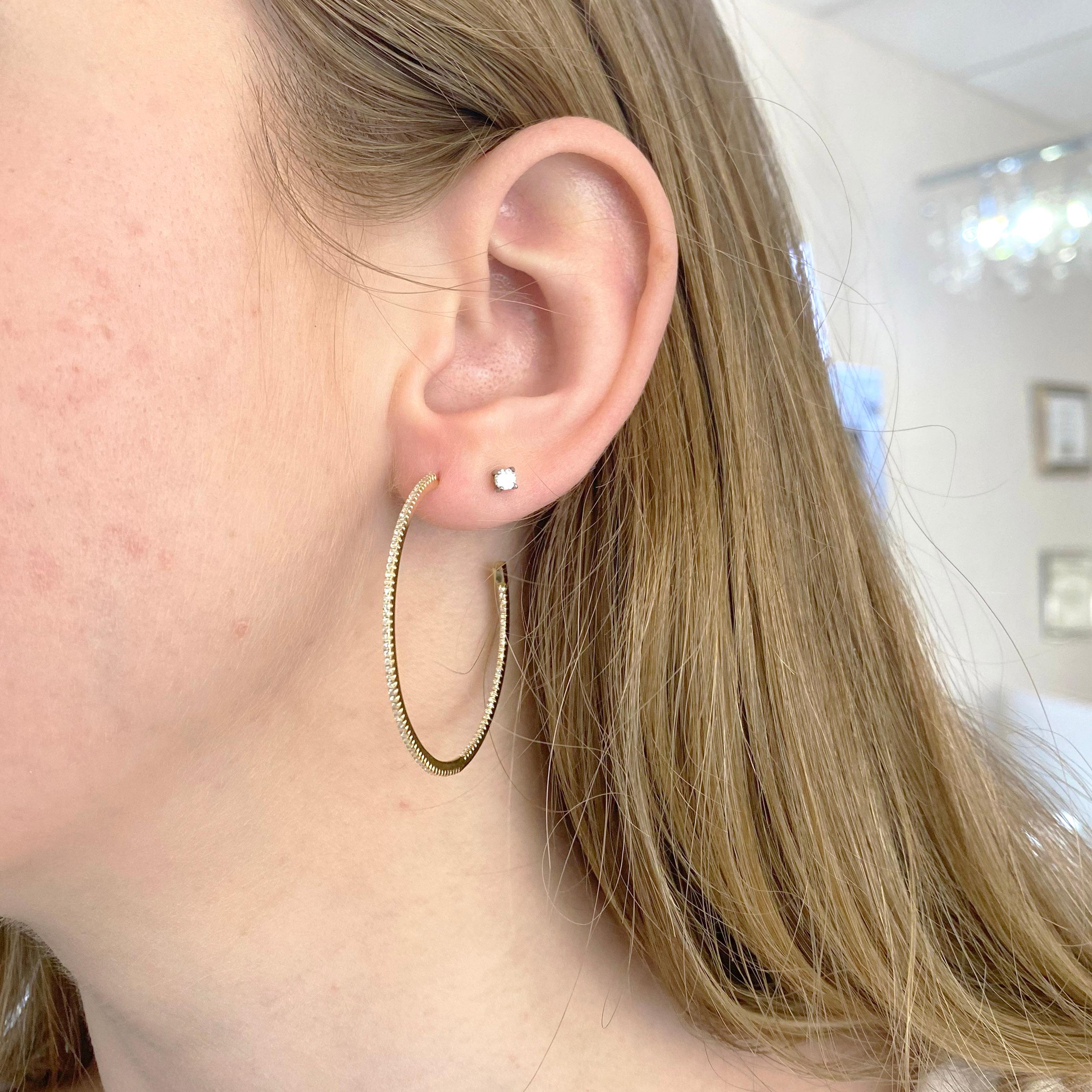 These 40 millimeters diamond hoop earrings are perfect for a bold look!  There are 92 diamonds on each earring and make a continuous round circle and the earrings are made in solid 14 karat yellow gold.  These earrings look great it’s long hair