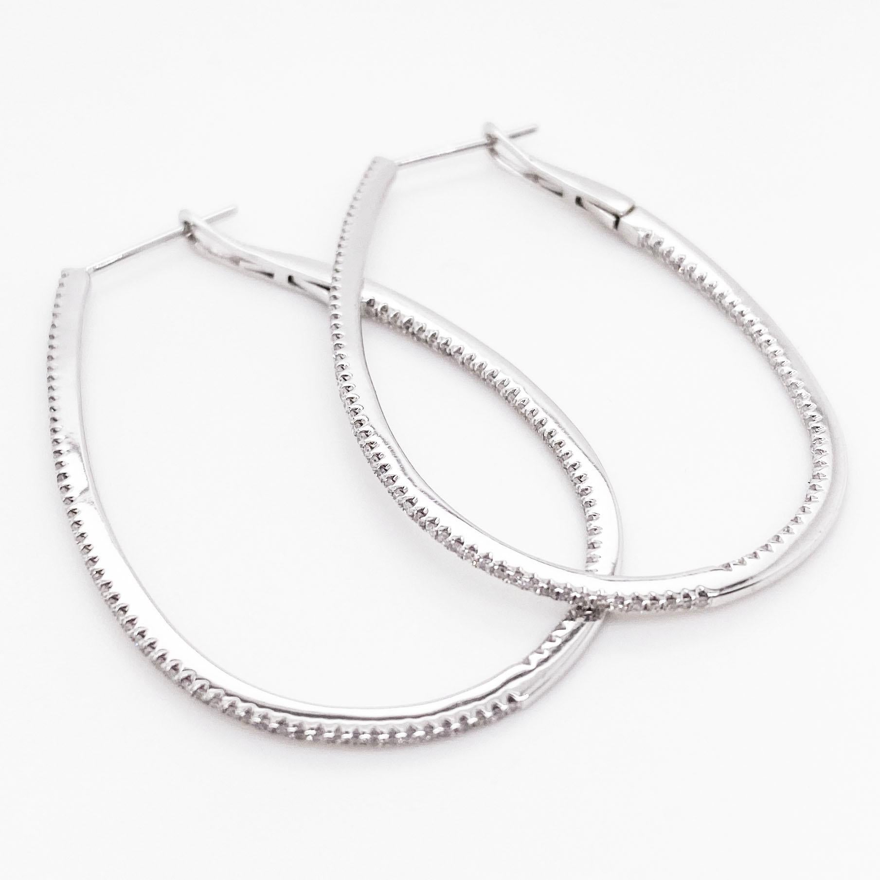 These extra large diamond inside out hoops are a staple in any fine jewelry collection. The elongated oval diameter is a unique hoop shape that's perfect for any occasion. They can be worn casually or for a more formal event. The hoops have round