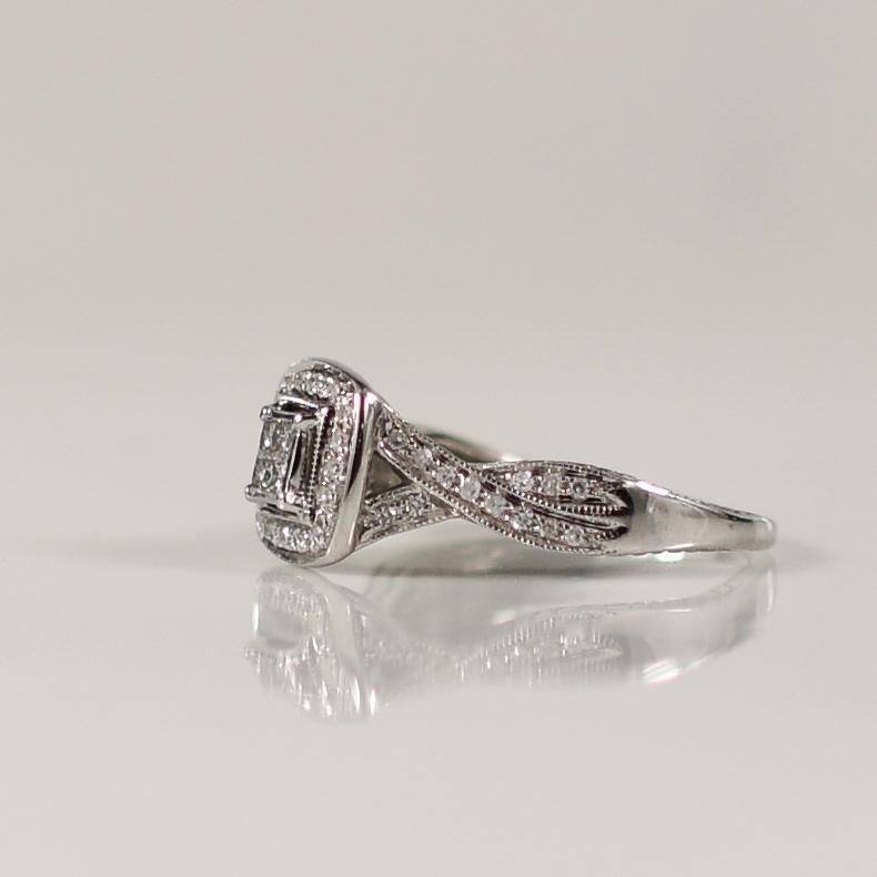 This contemporary ring features a stunning quartet of princess-cut diamonds at its center, creating a dazzling focal point. Surrounding the central diamonds is a sparkling halo of smaller diamonds, enhancing their brilliance and allure. The winding