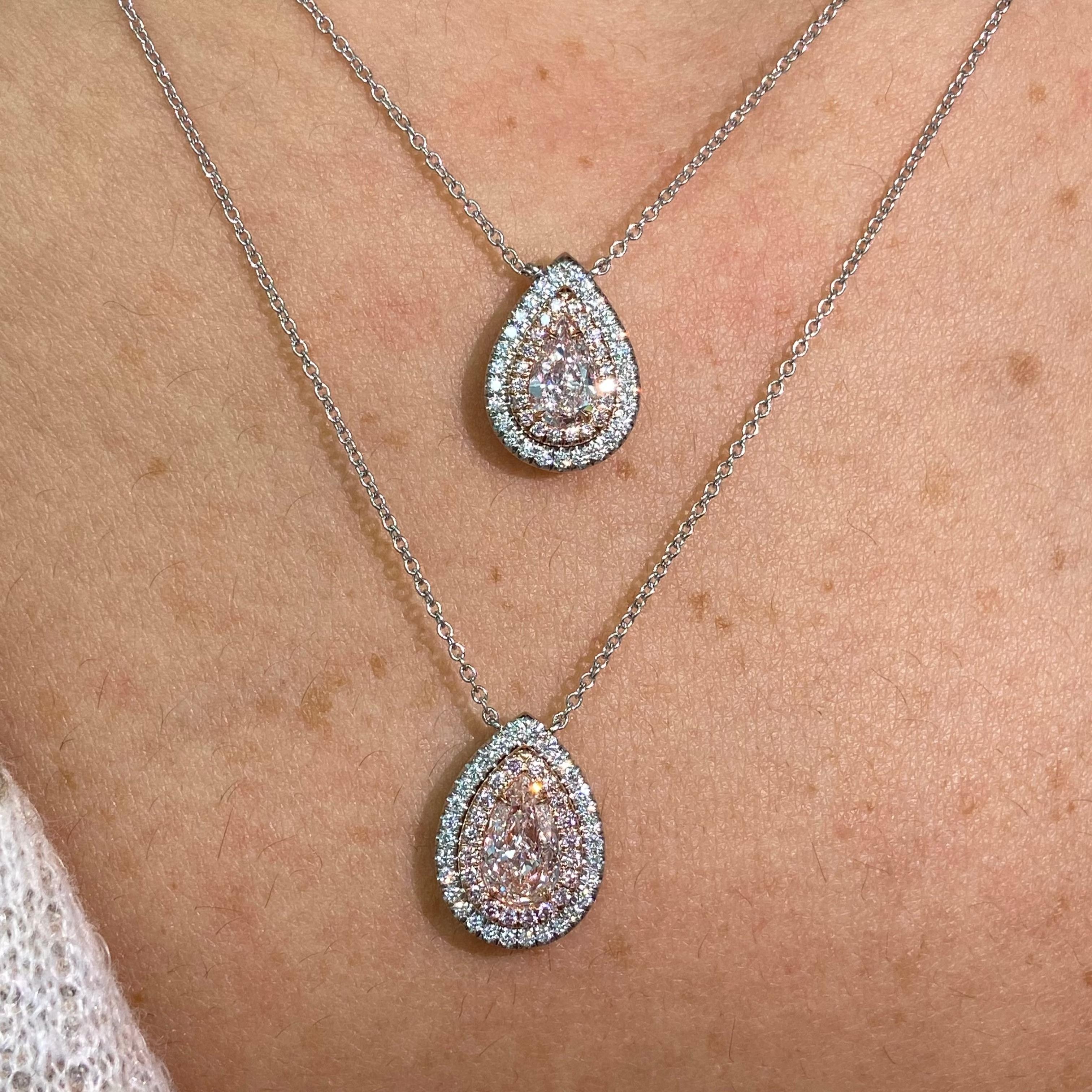 This elegant pink diamond double halo pendant showcases a delicate 0.54 carat light pink pear shape diamond with exceptional VVS2 clarity, radiating soft, romantic brilliance. Framed by 0.25 carats of pink and white diamonds, the double halo