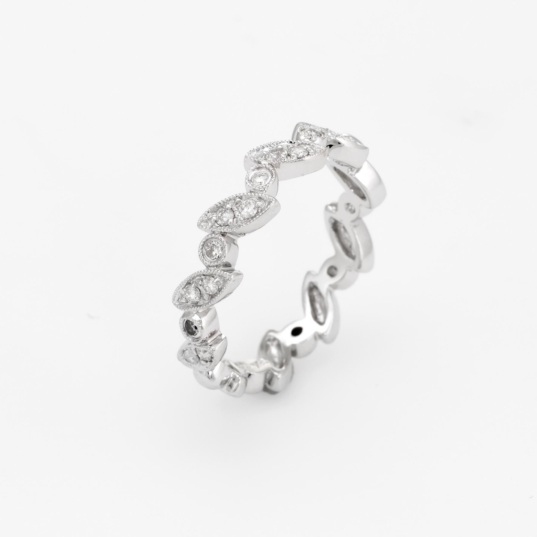 Stylish half diamond band crafted in 18k white gold.

Round brilliant cut diamonds total an estimated 0.07 carats (estimated at H-I color and SI1-I1 clarity). 

The elegant band is set with a visually appealing alternating pattern of marquise and